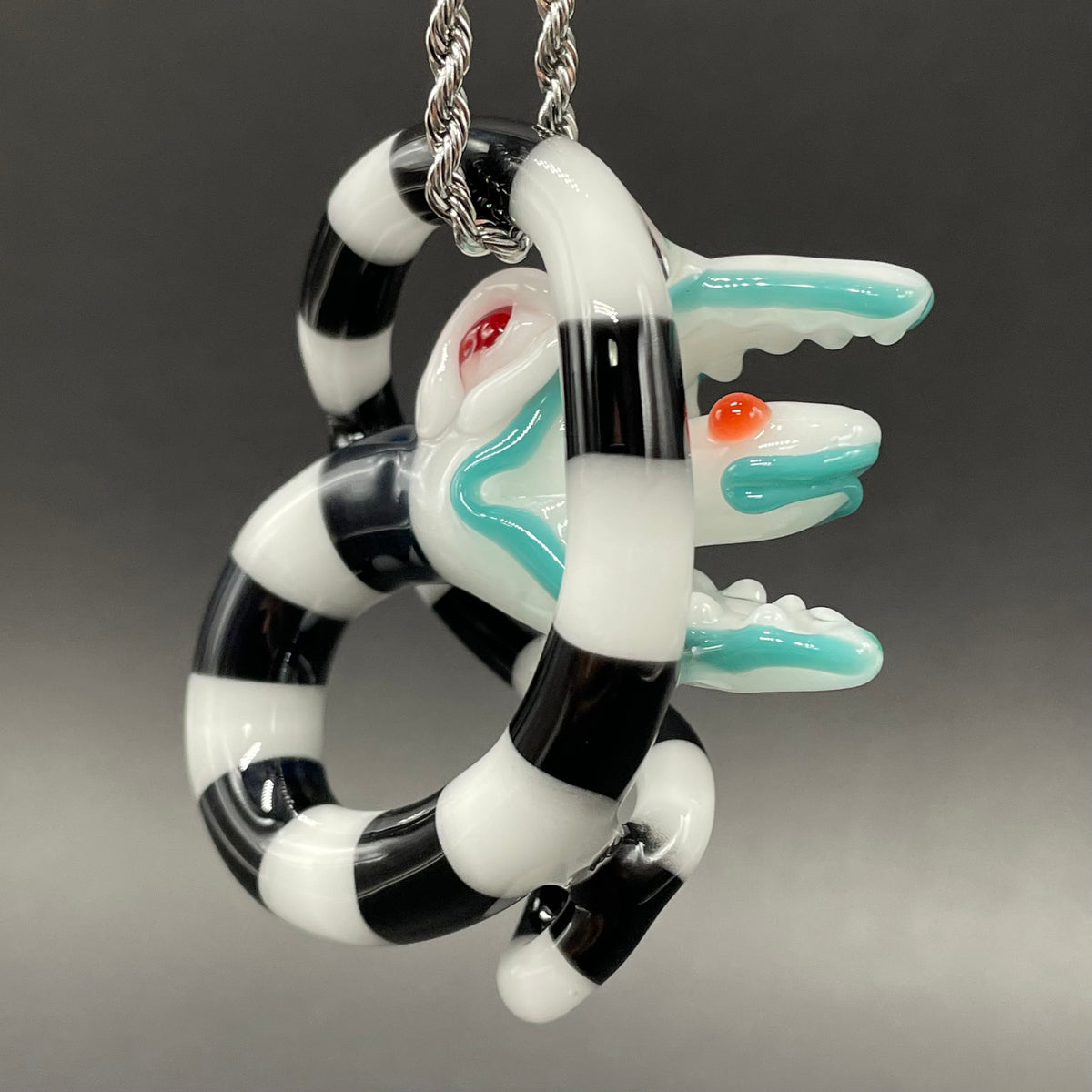 Beetlejuice Inspired handblown solid glass Sandworm sculpture - coiled black and white striped sandworm with white worm head, teal tongue, red eyes - Leviathan Glass