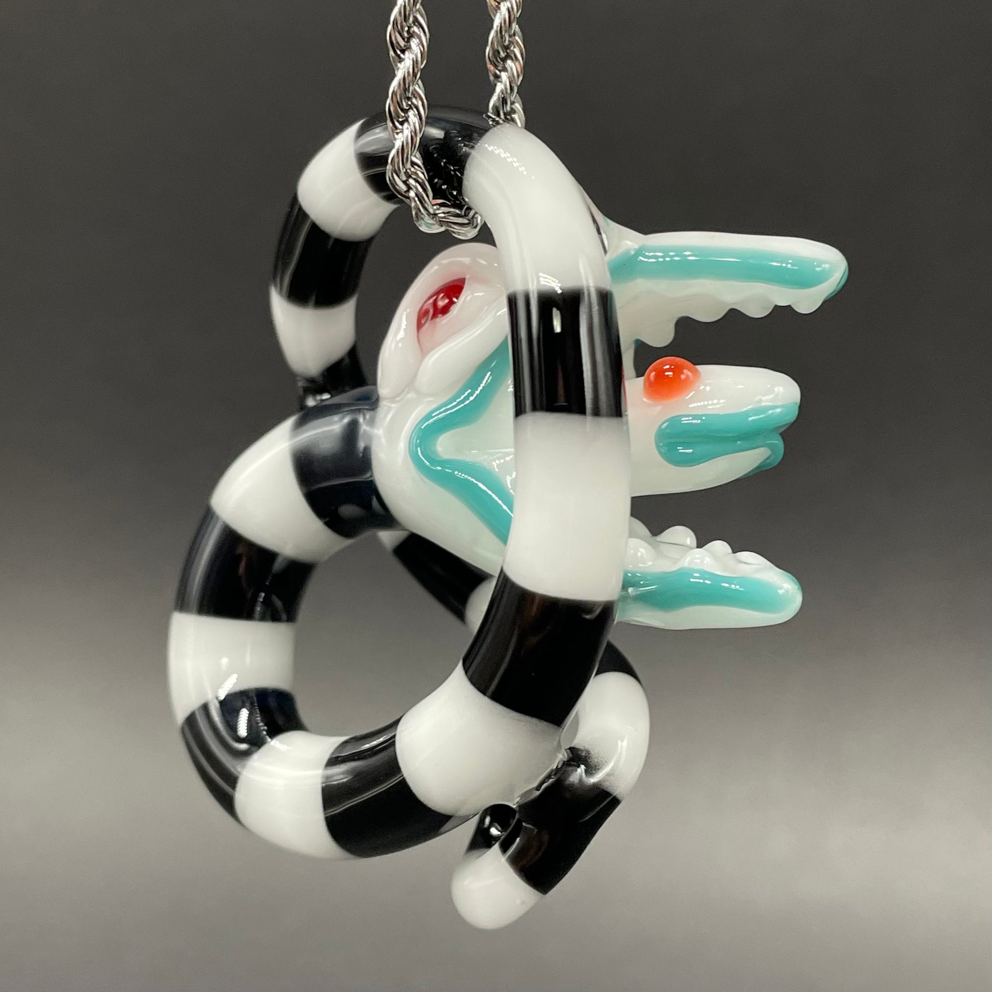 Beetlejuice Inspired handblown solid glass Sandworm sculpture - coiled black and white striped sandworm with white worm head, teal tongue, red eyes - Leviathan Glass