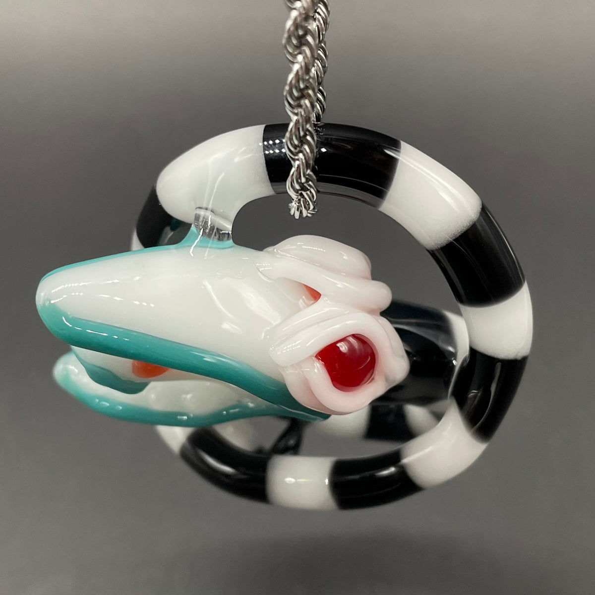 Beetlejuice Inspired handblown solid glass Sandworm sculpture - coiled black and white striped sandworm with white worm head, teal tongue, red eyes - Leviathan Glass