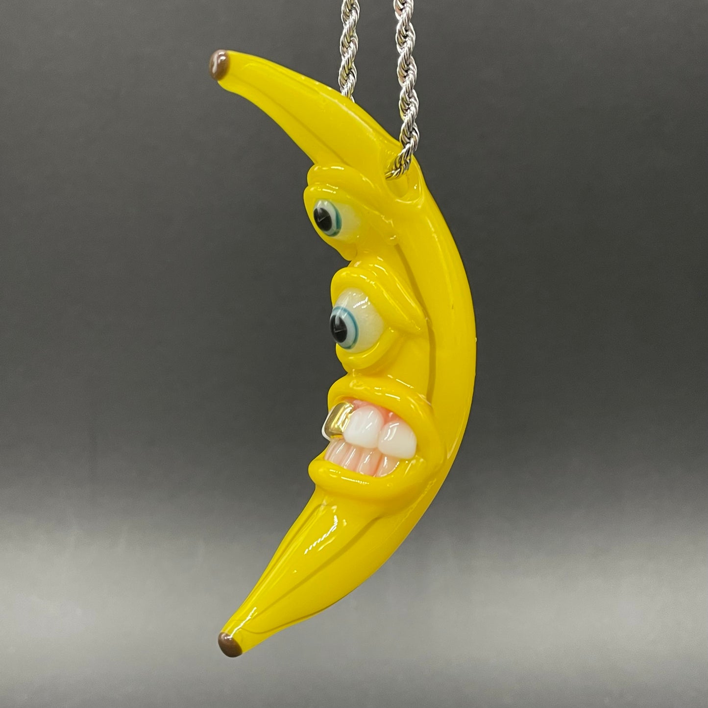 Grinning glass banana pendant