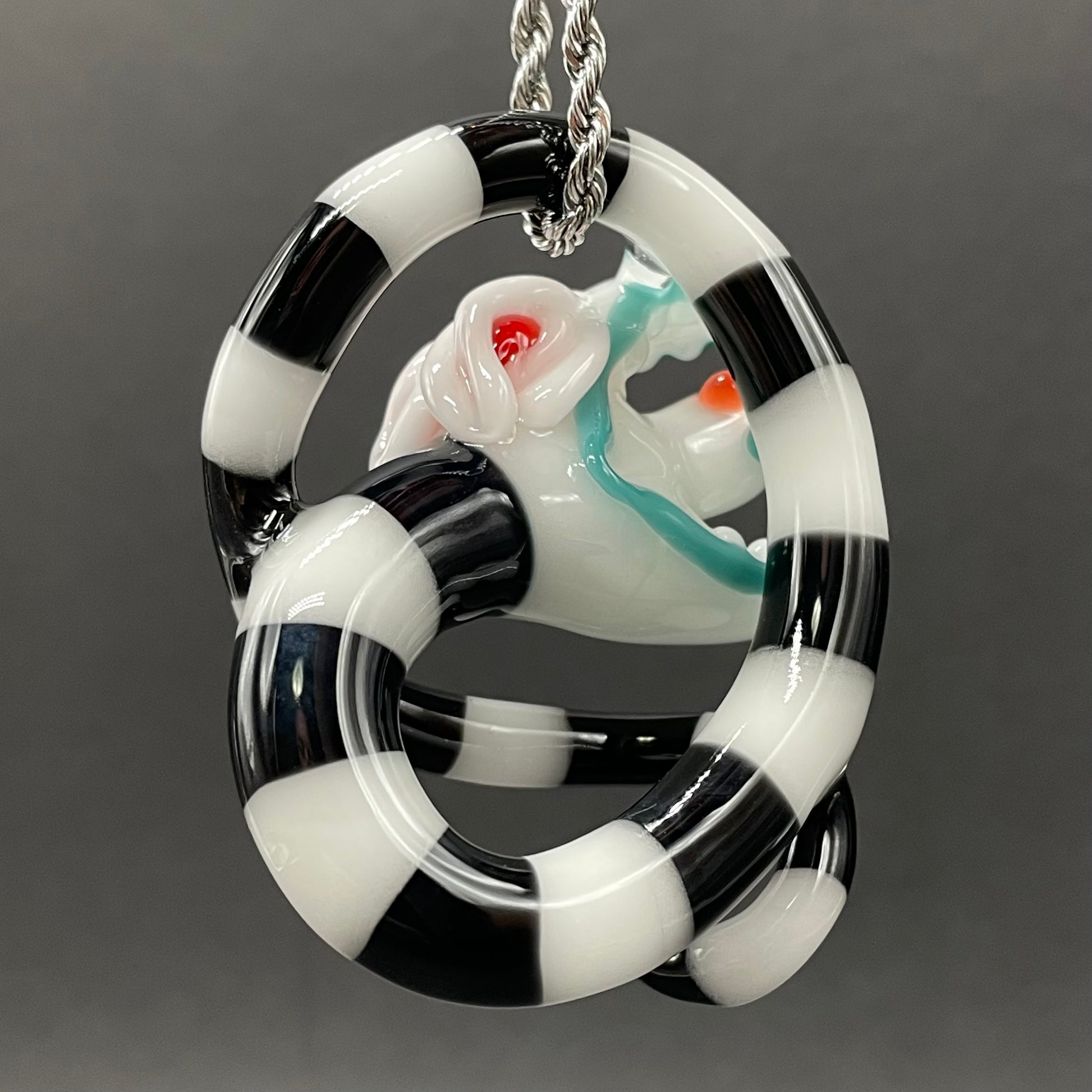 Beetlejuice Inspired handblown solid glass Sandworm sculpture - coiled black and white striped sandworm with white worm head, teal tongue, red eyes - Leviathan Glass