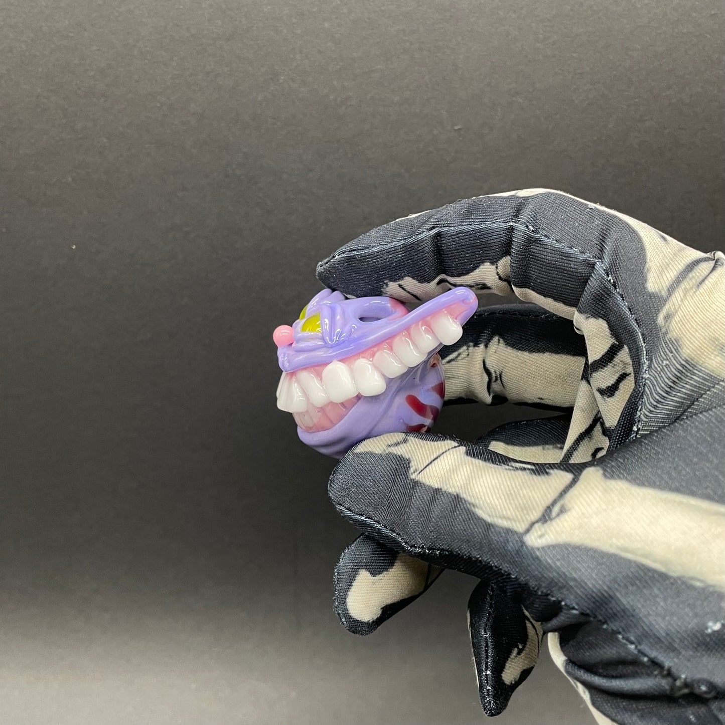 Grinning Cheshire cat glass pendant