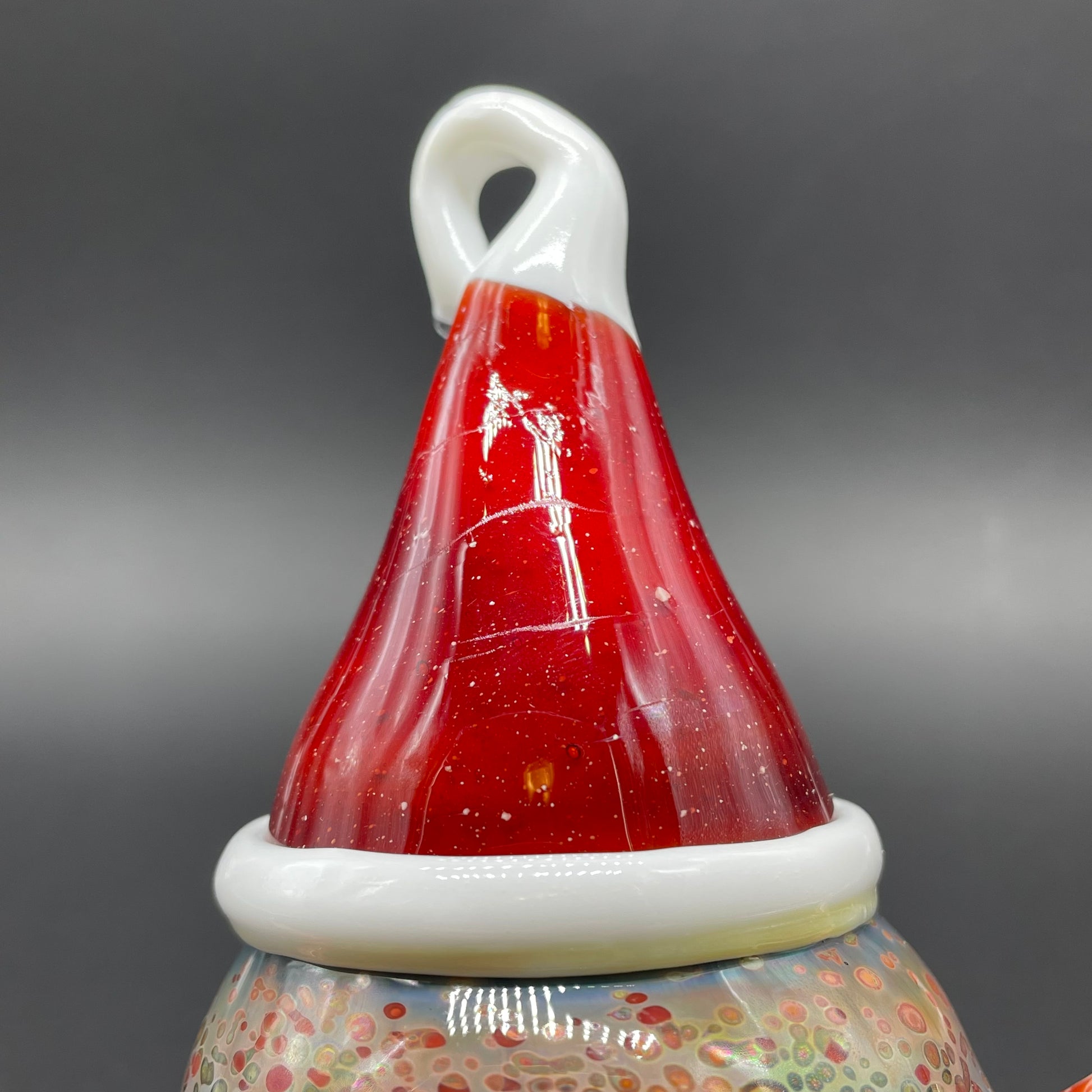 Close-up of Santa hat cyclops ornament - handcrafted glass