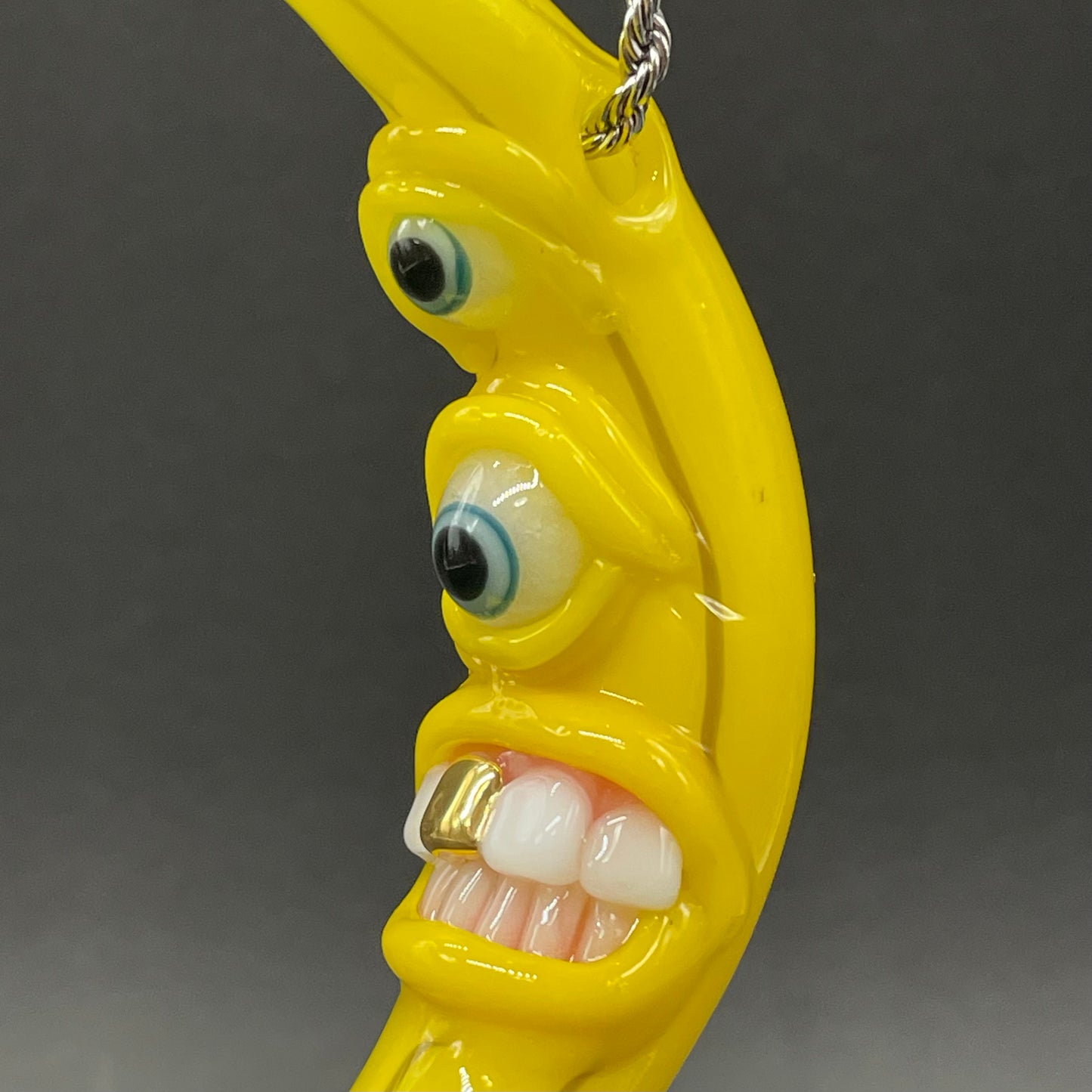 Grinning glass banana pendant