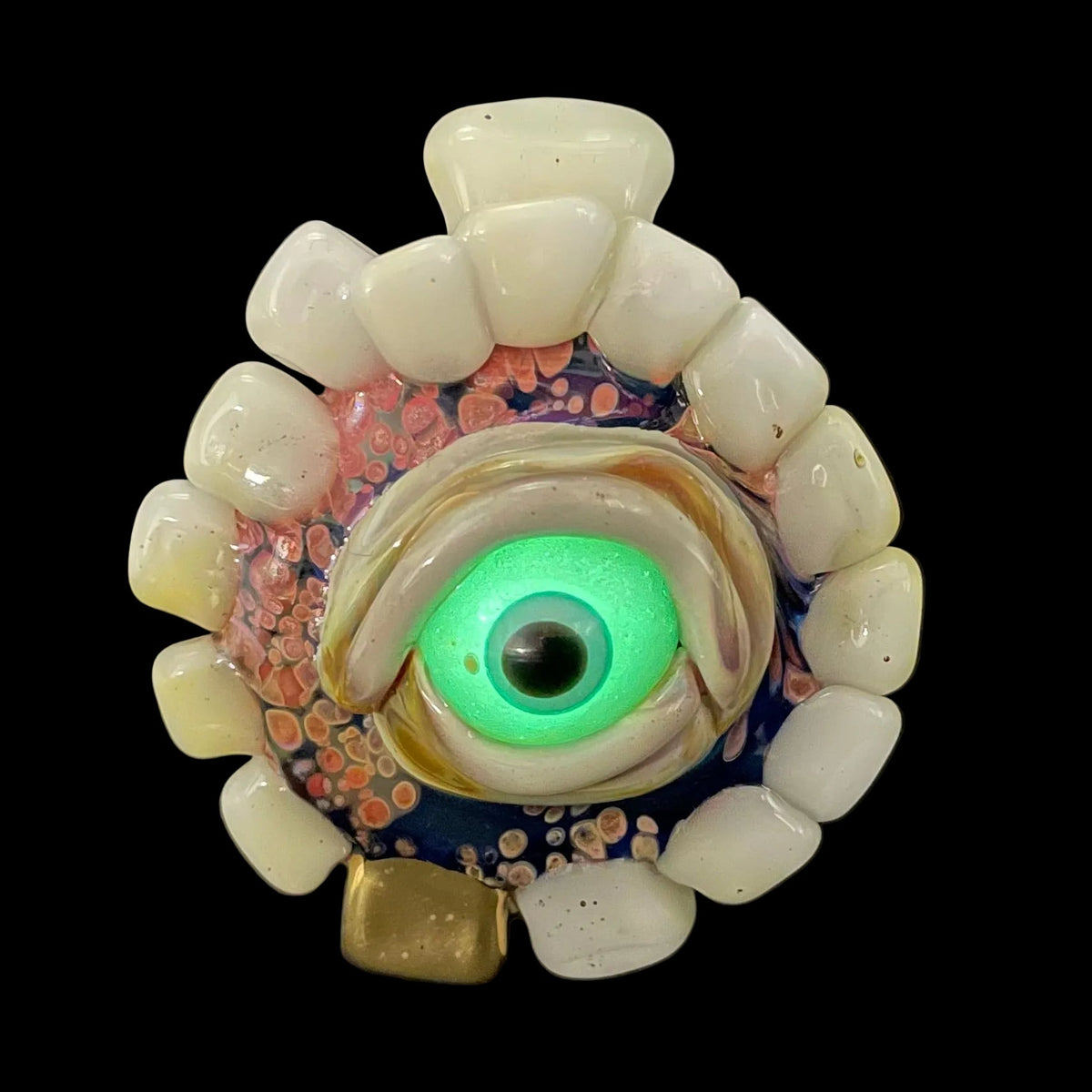 Unidentified Object Delta handblown glass pendant - circular disc ringed with ivory teeth, blue iris eye center, eyelid, gold tooth accent, silver rope chain - Leviathan Glass