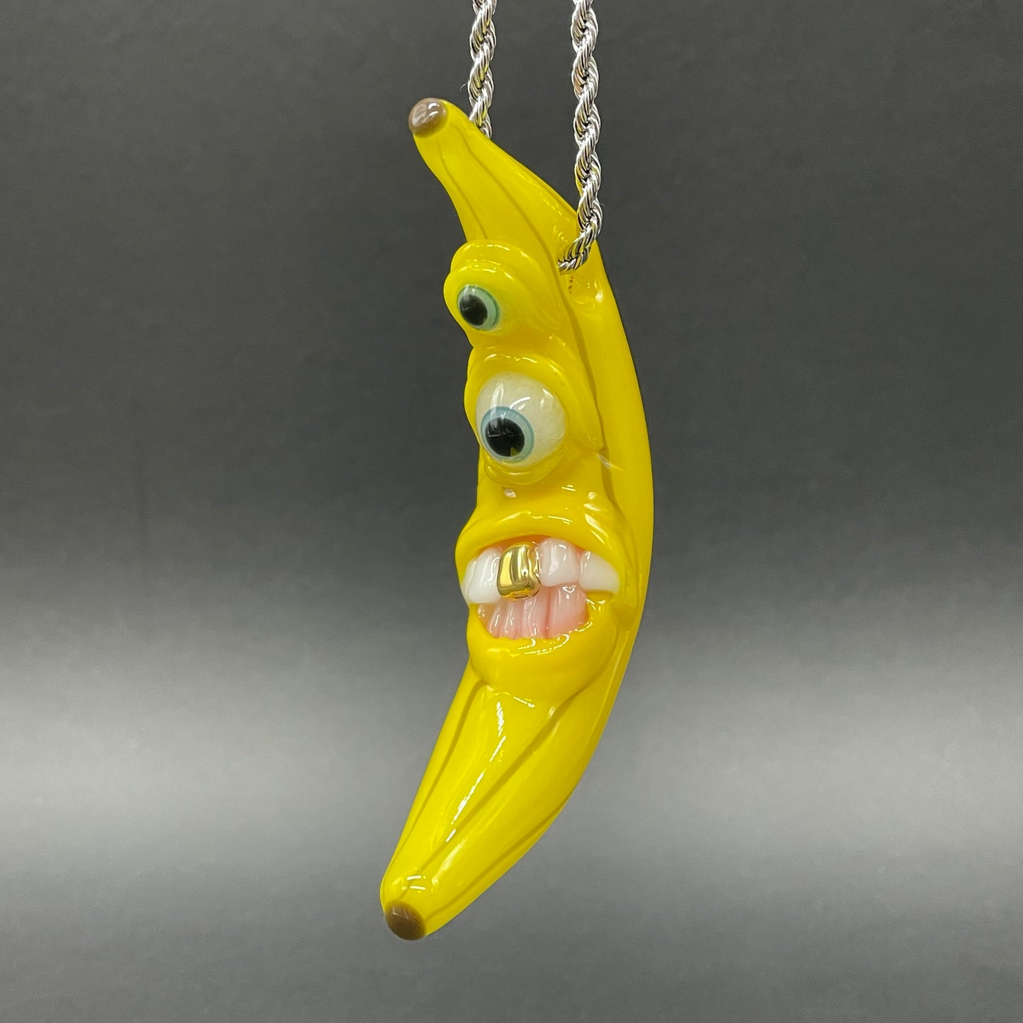 Grinning glass banana pendant