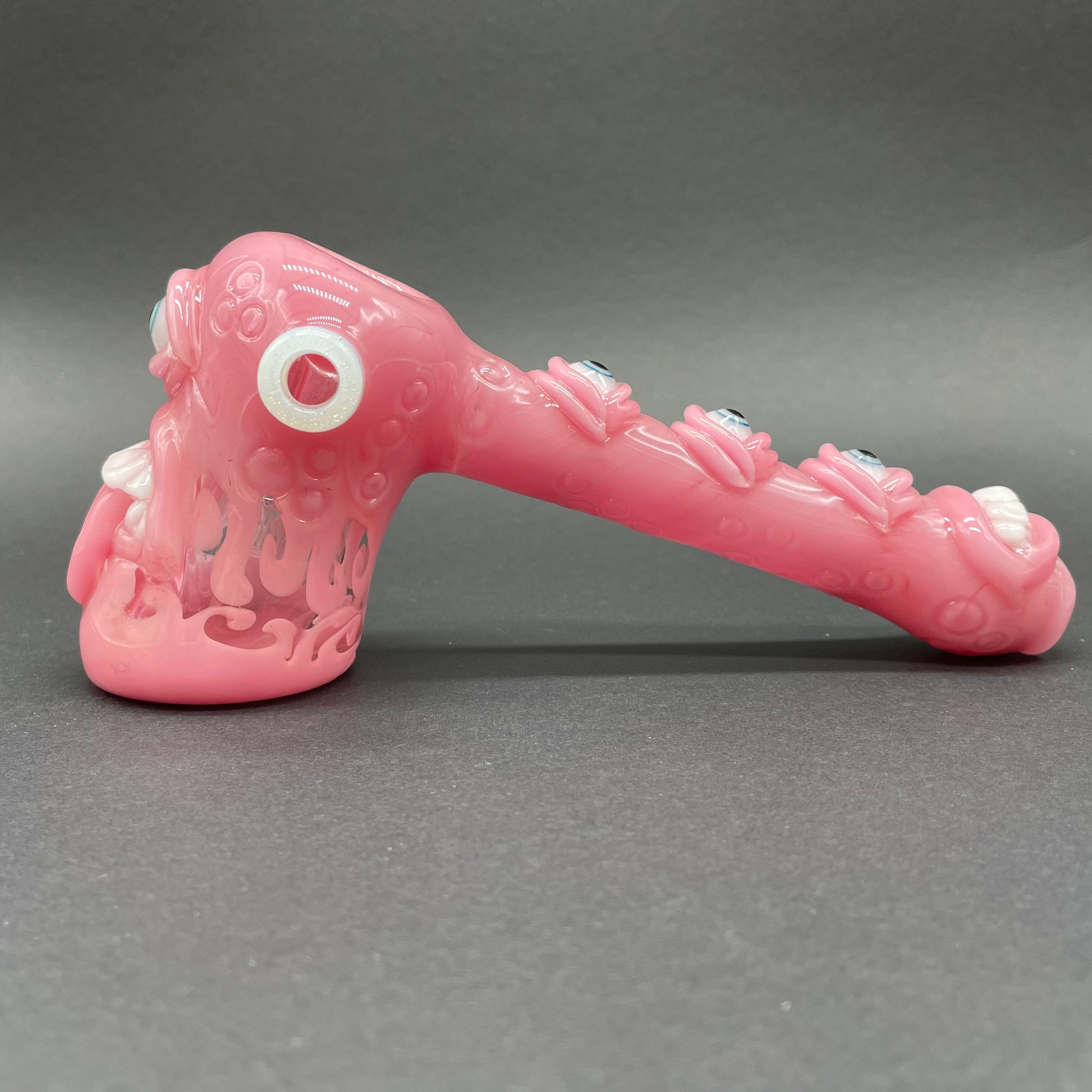 Close-up of Pink evil eye bubbler - handcrafted glass