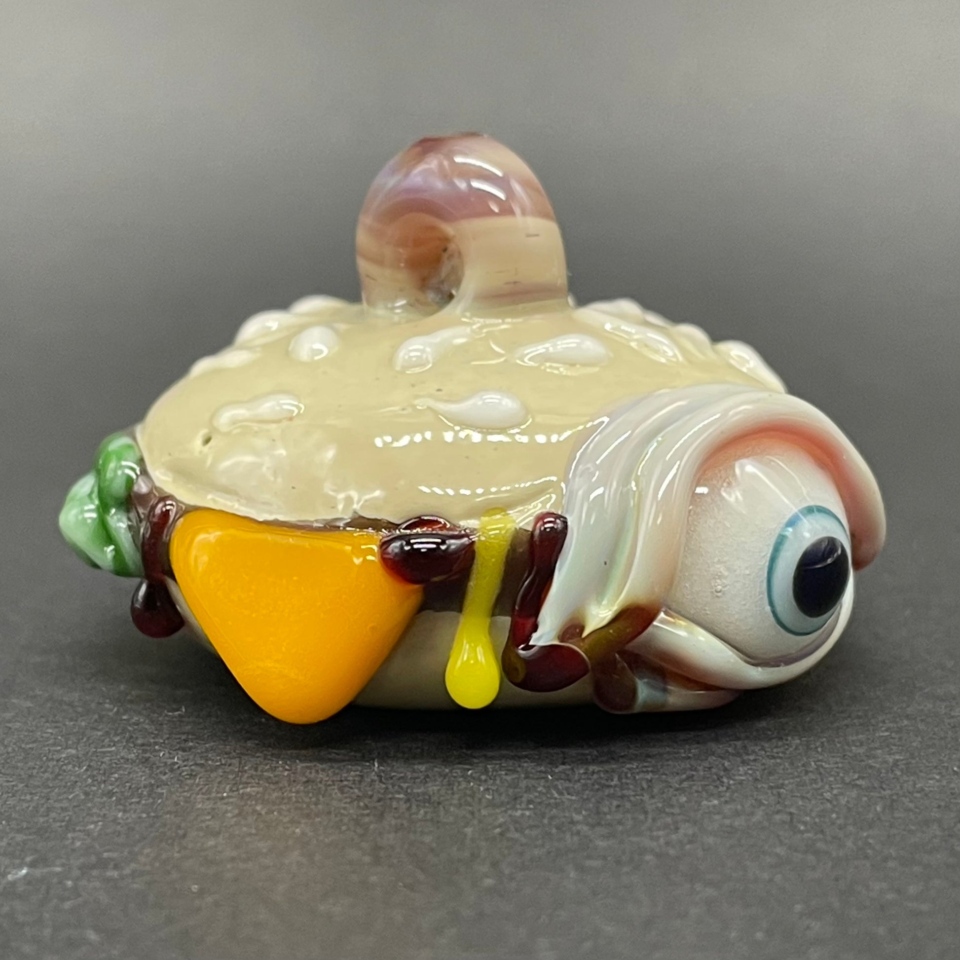 Close-up of Eye love cheeseburger pendant - handcrafted glass