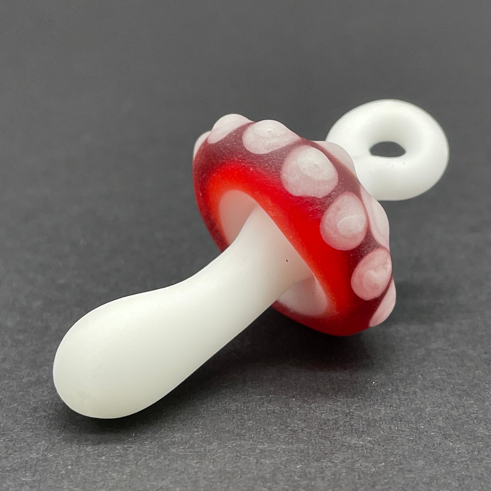 Close-up of Red mushroom pendant - handcrafted glass