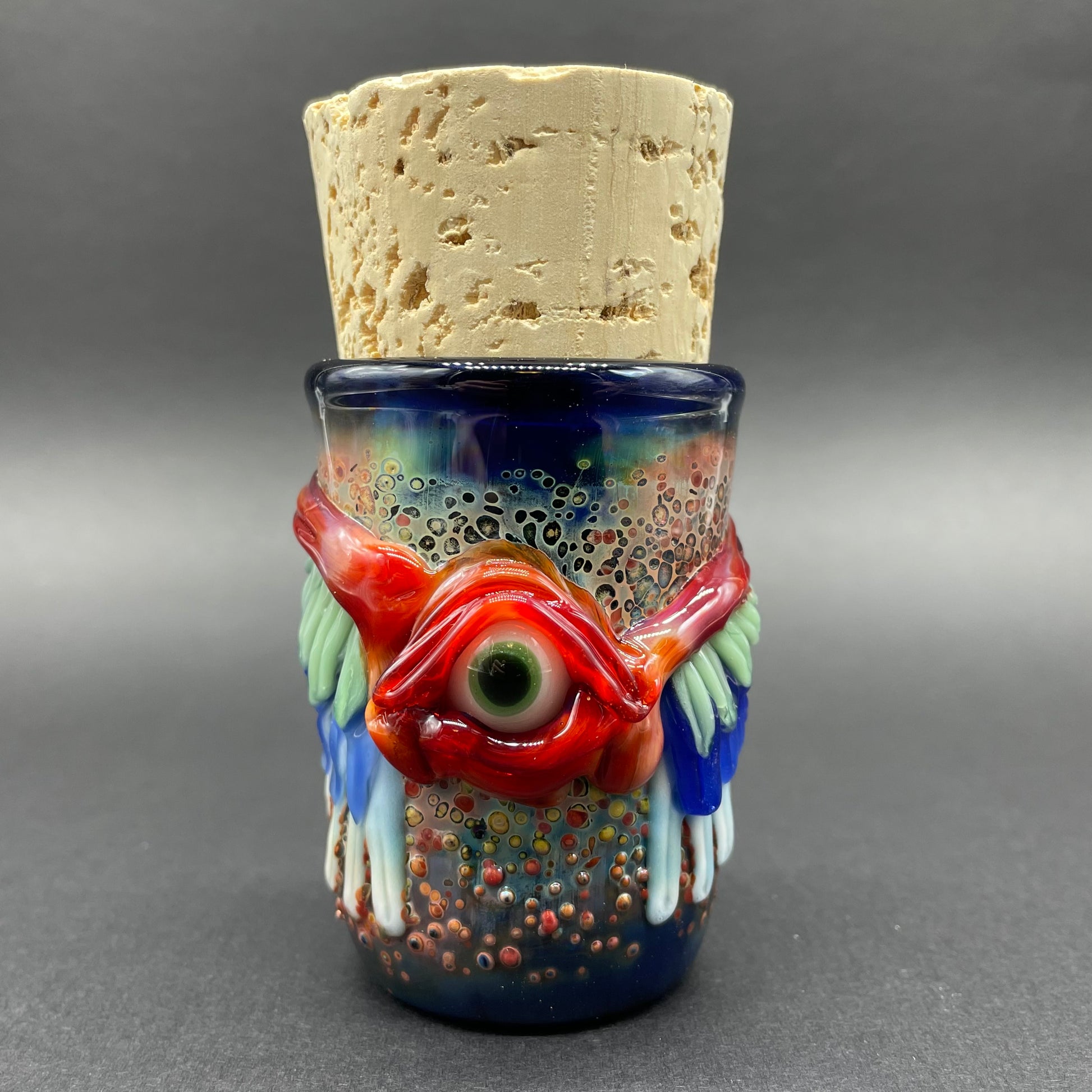 Winged phoenix cork jar detail view - premium glass art