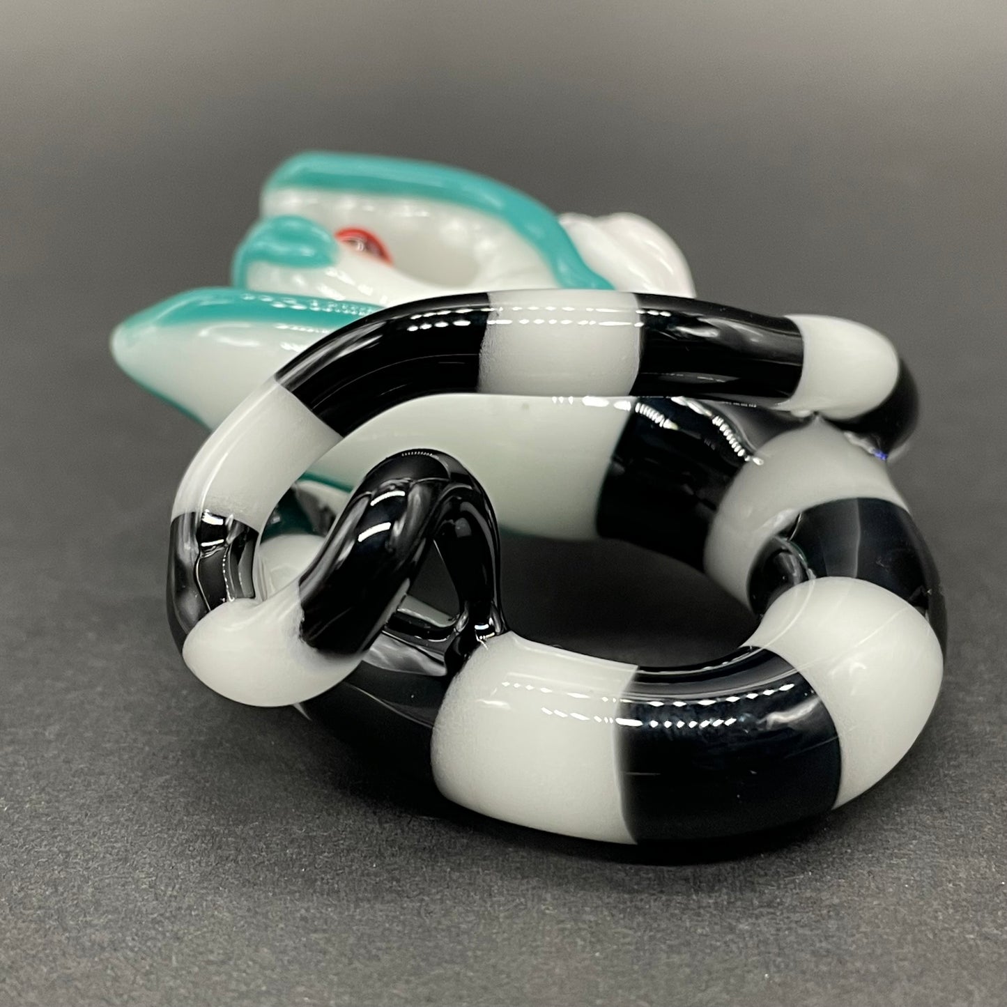 Beetlejuice Inspired handblown solid glass Sandworm sculpture - coiled black and white striped sandworm with white worm head, teal tongue, red eyes - Leviathan Glass