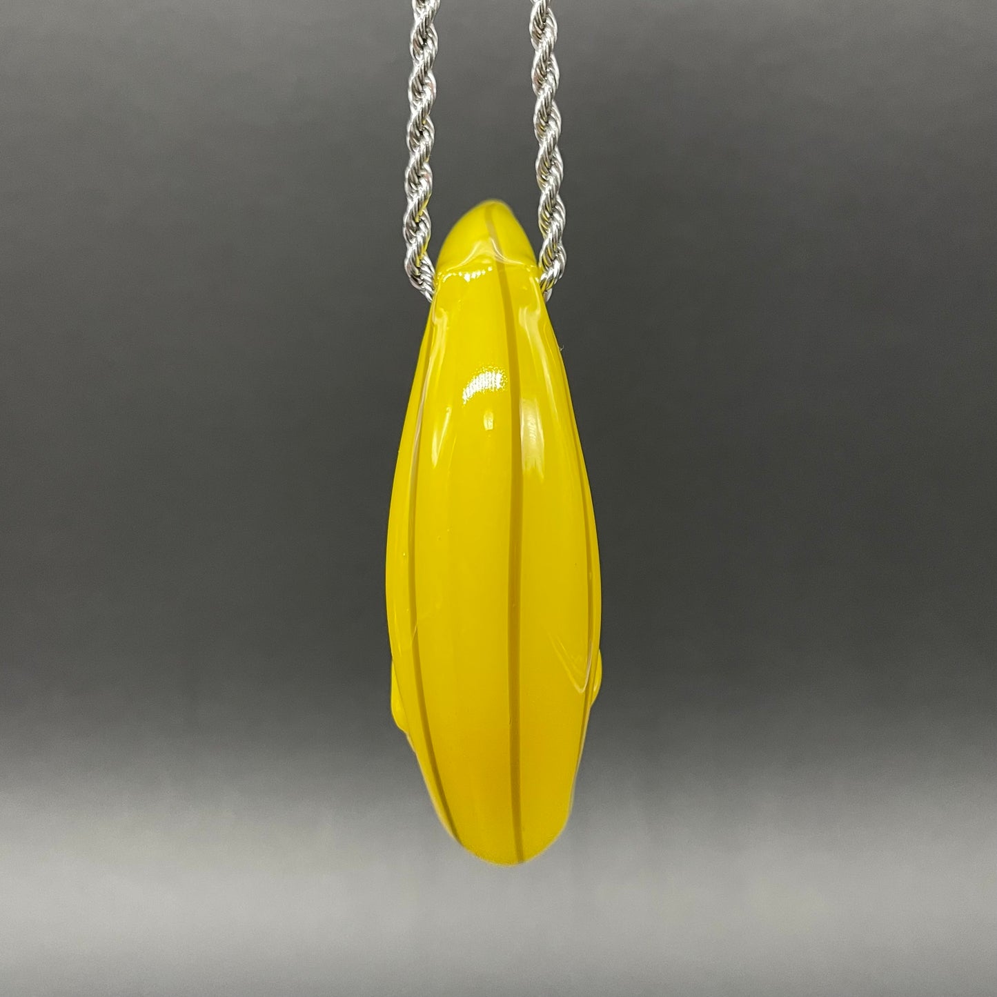 Grinning glass banana pendant