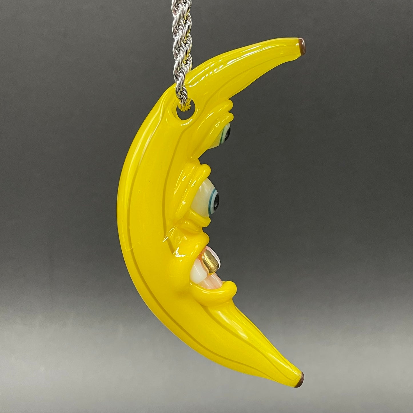 Grinning glass banana pendant
