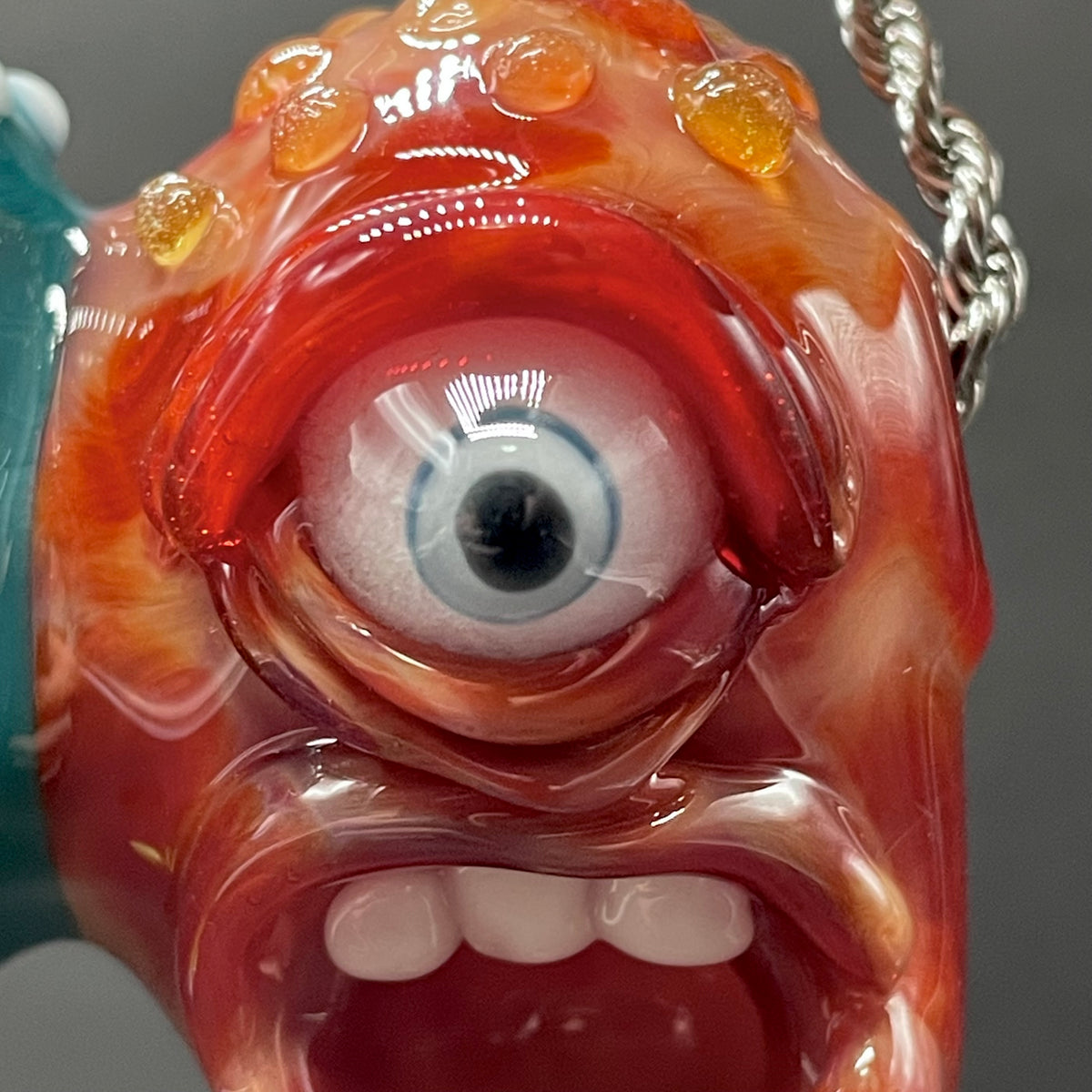 Two Headaches Are Better Than One handblown glass pendant - teal cyclops head with white teeth and green slime fused with red cyclops head with pink tongue, silver rope chain - Leviathan Glass