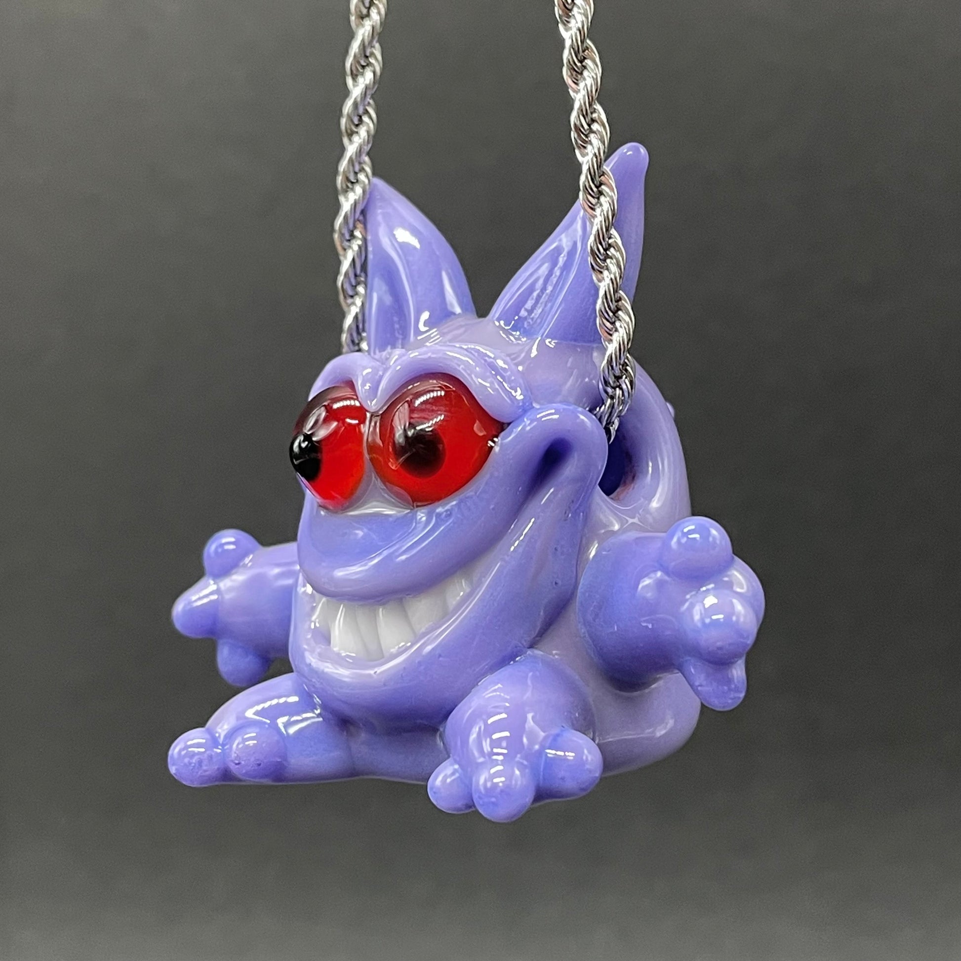 Gengar Pokémon handblown glass pendant - periwinkle purple Gengar sculpture, large red glass eyes, white teeth, clawed hands and feet, silver rope chain - Leviathan Glass