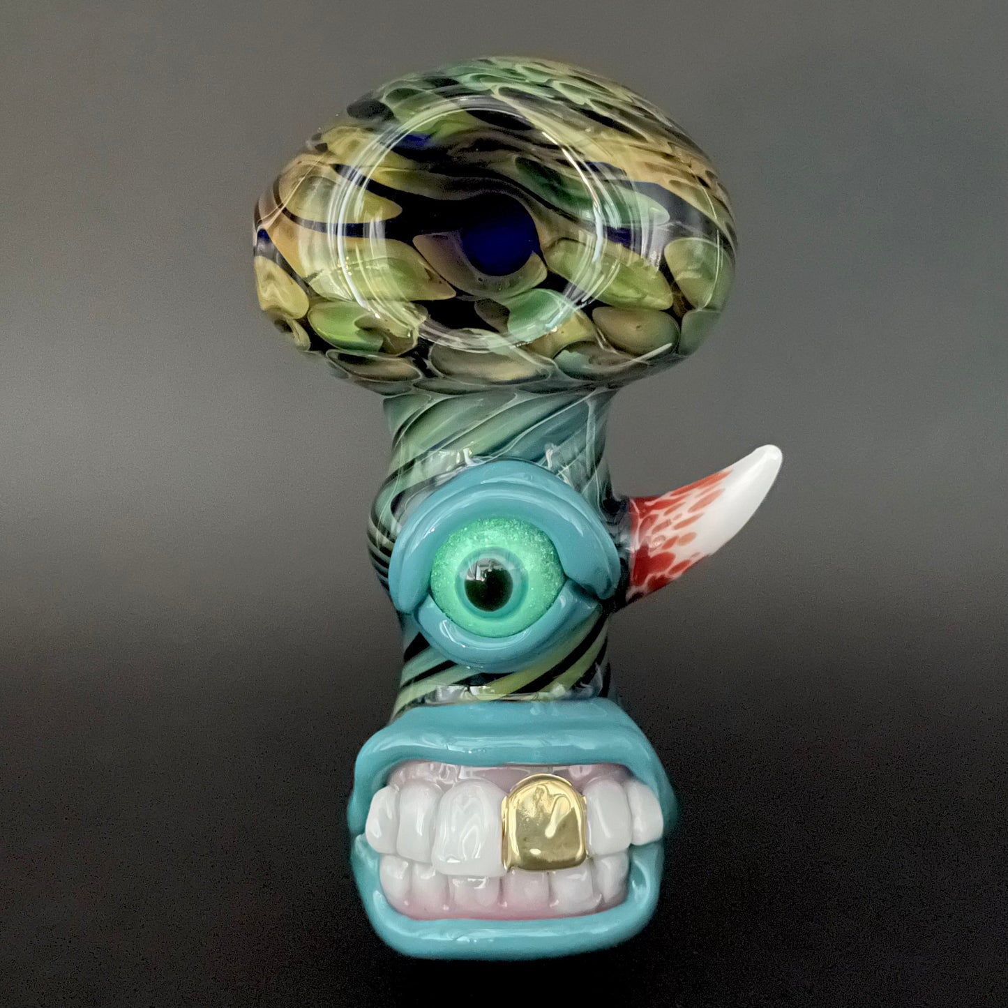 Close-up of Gold Fumed Cyclops Spoon - handcrafted glass