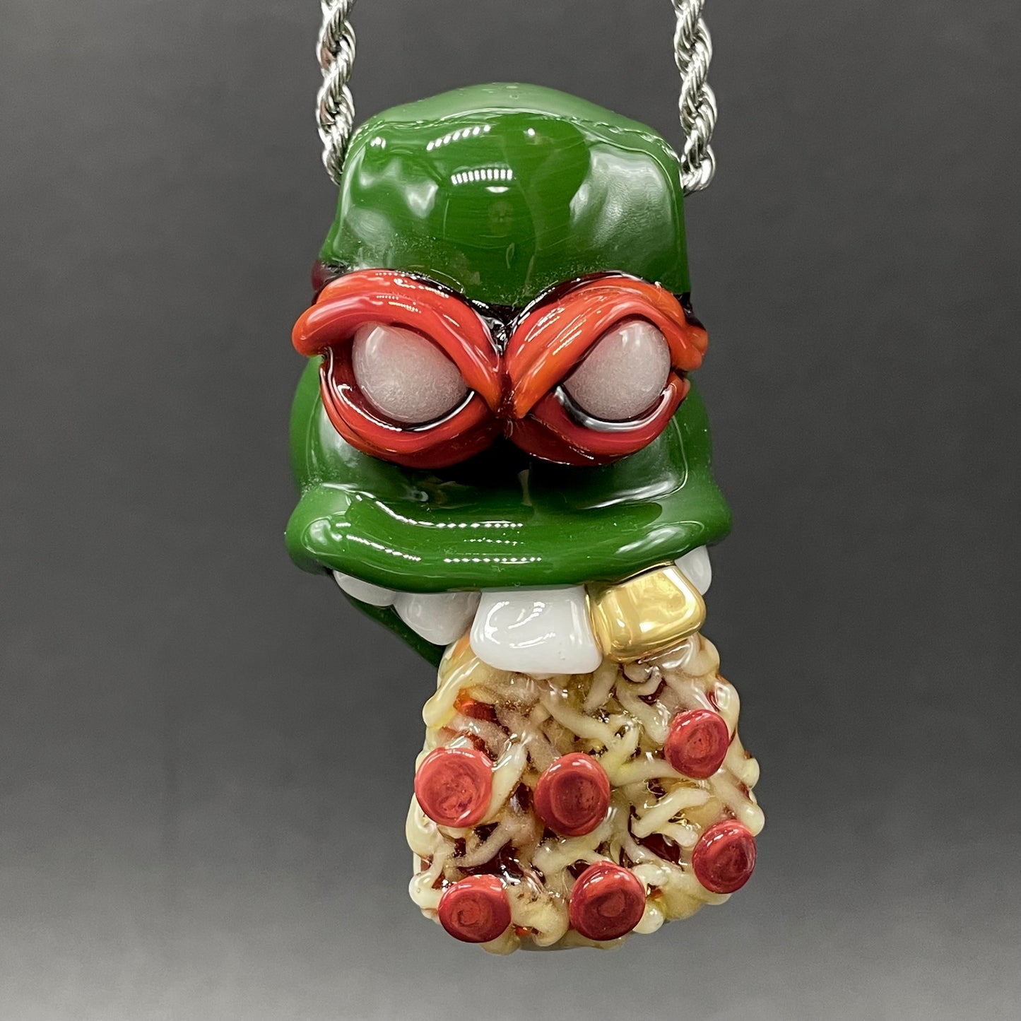 Close-up of Glass Ninja Turtle Pendant – Handmade Raphael Pizza Necklace, TMNT Fan Jewelry - handcrafted glass