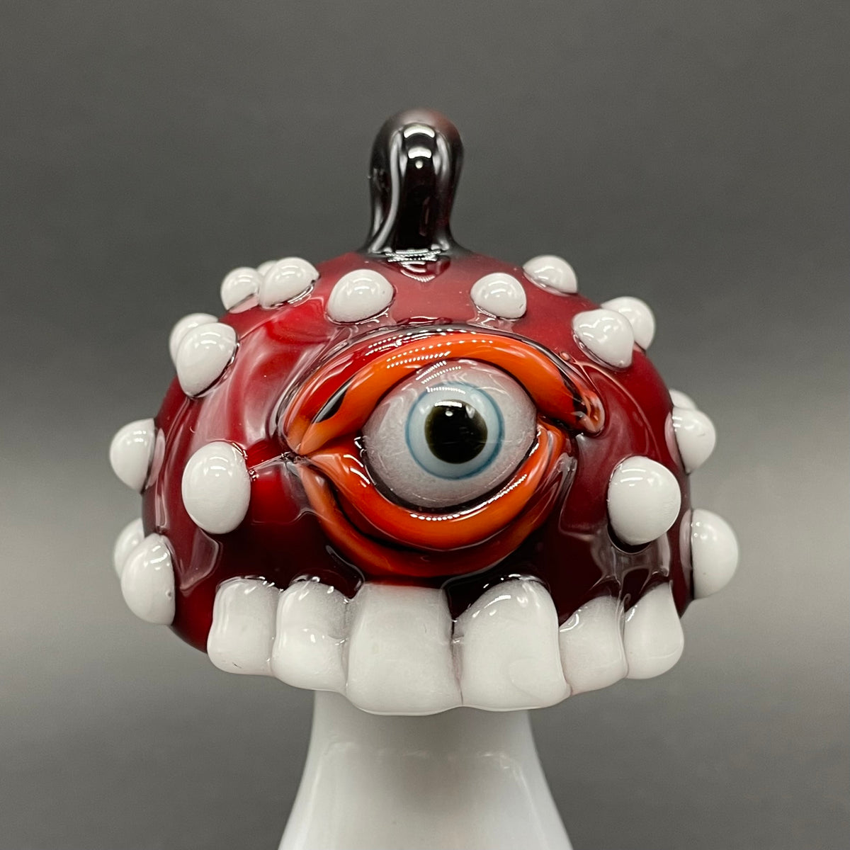 Close-up of Cyclops mushroom ornament - handcrafted glass