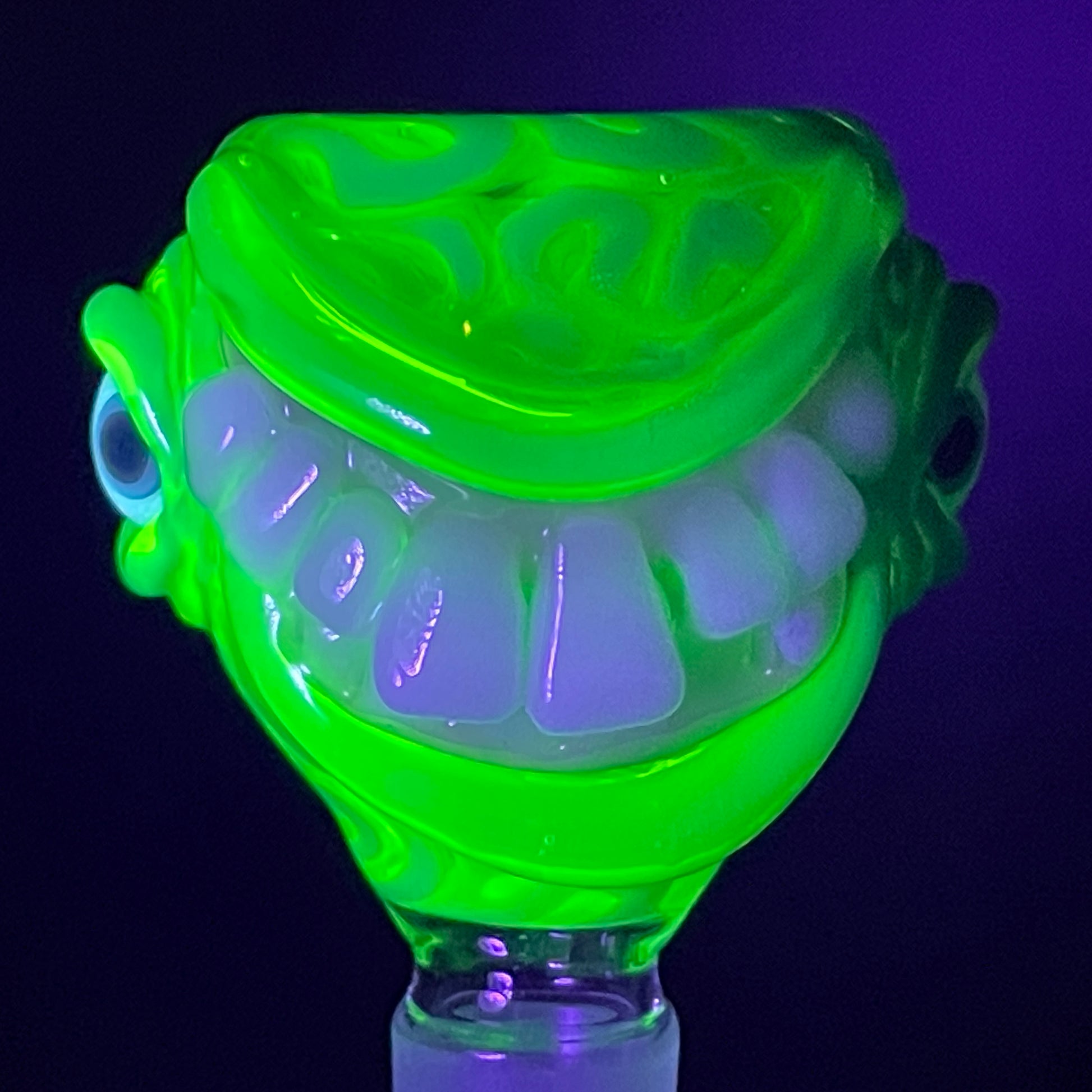 Close-up of 14mm uv smiley face slide - handcrafted glass