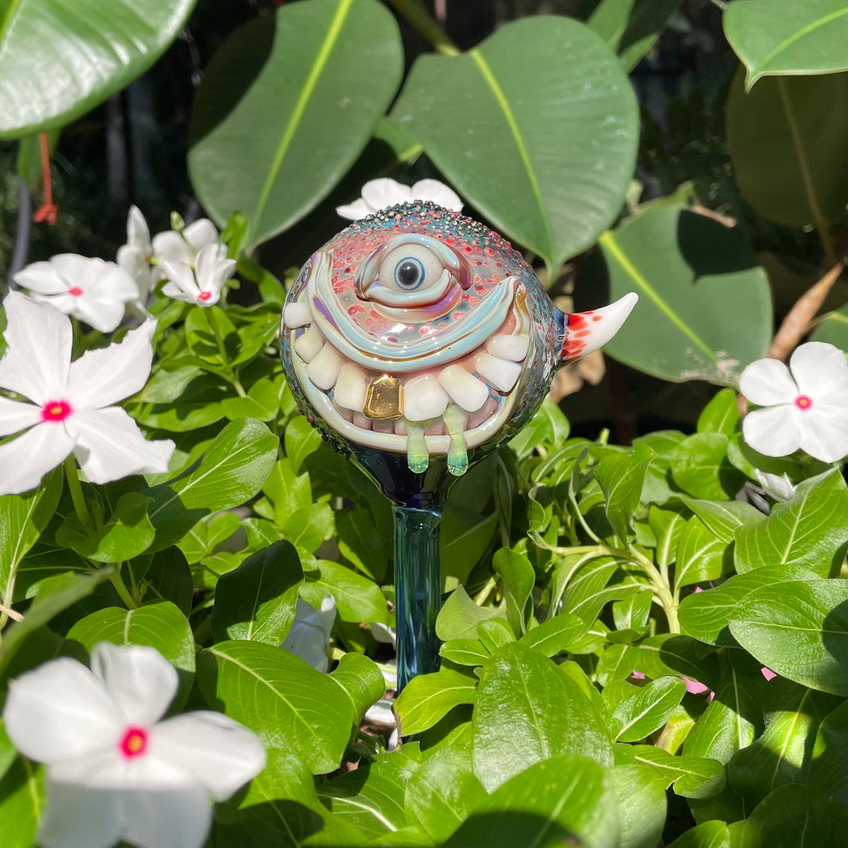 Hand Blown Glass Monster Watering Globe - round cyclops head, blue iris eye, white teeth, gold tooth, teal tongue drips, teal glass stake - Leviathan Glass