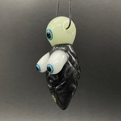 Close-up of Black light reactive fertility pendant - handcrafted glass