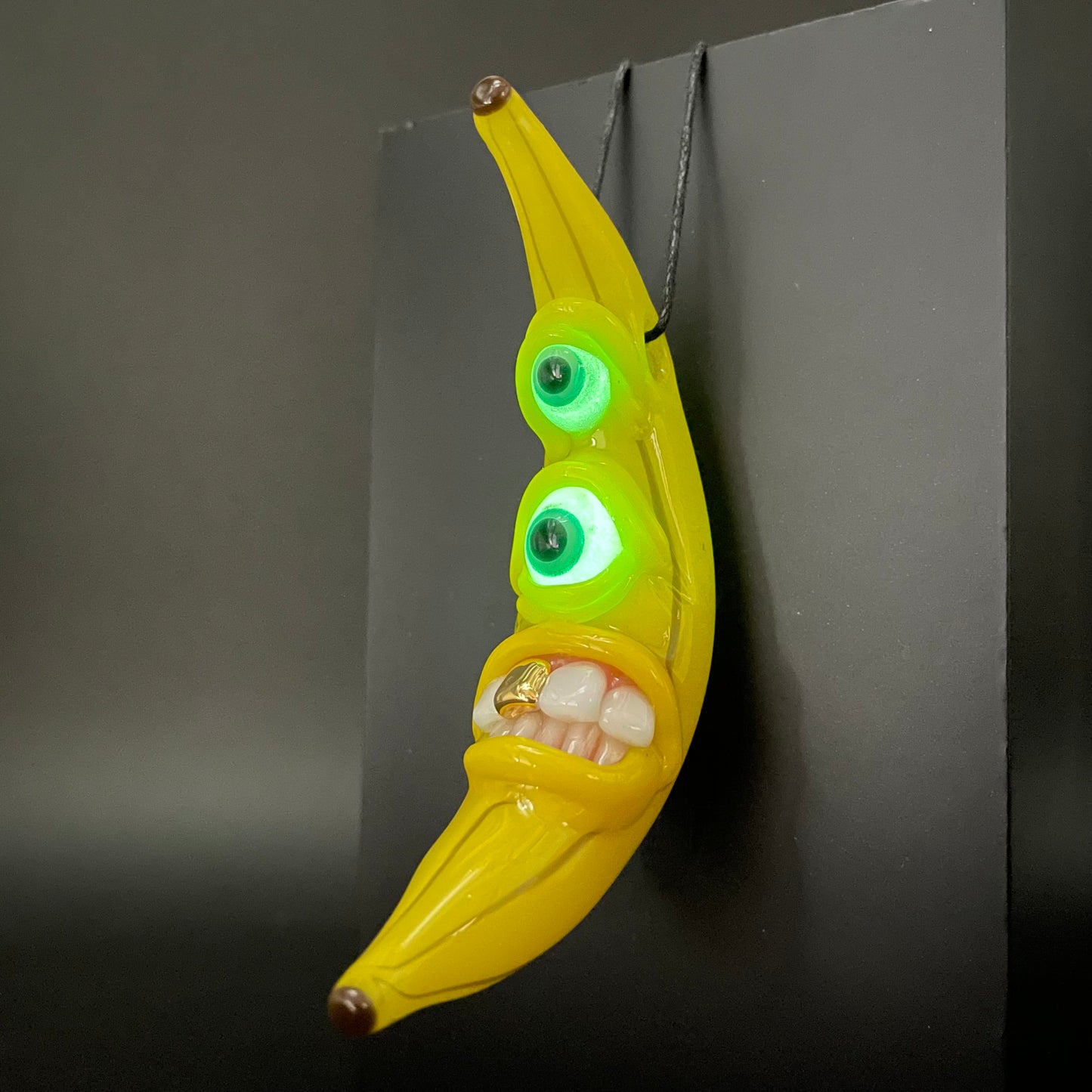 Grinning glass banana pendant
