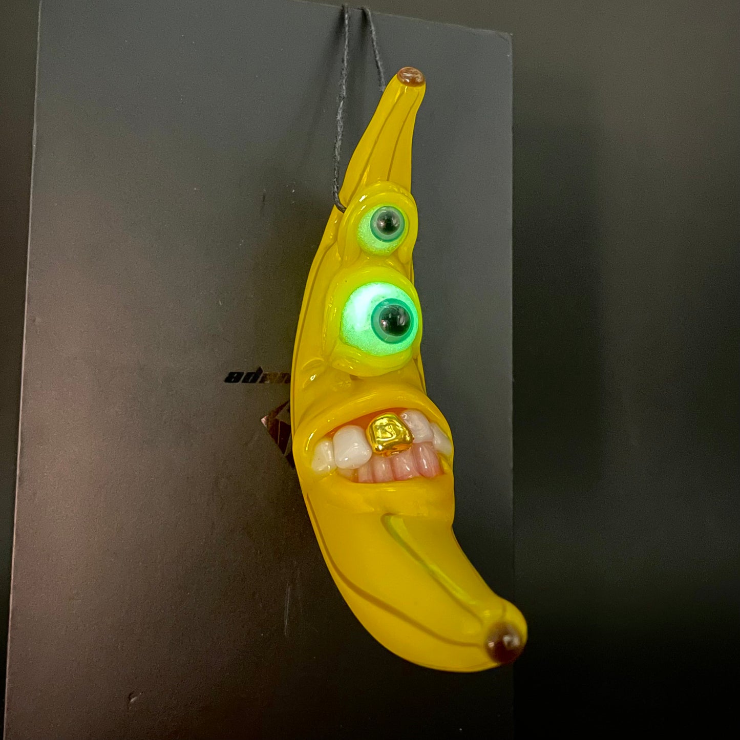 Grinning glass banana pendant