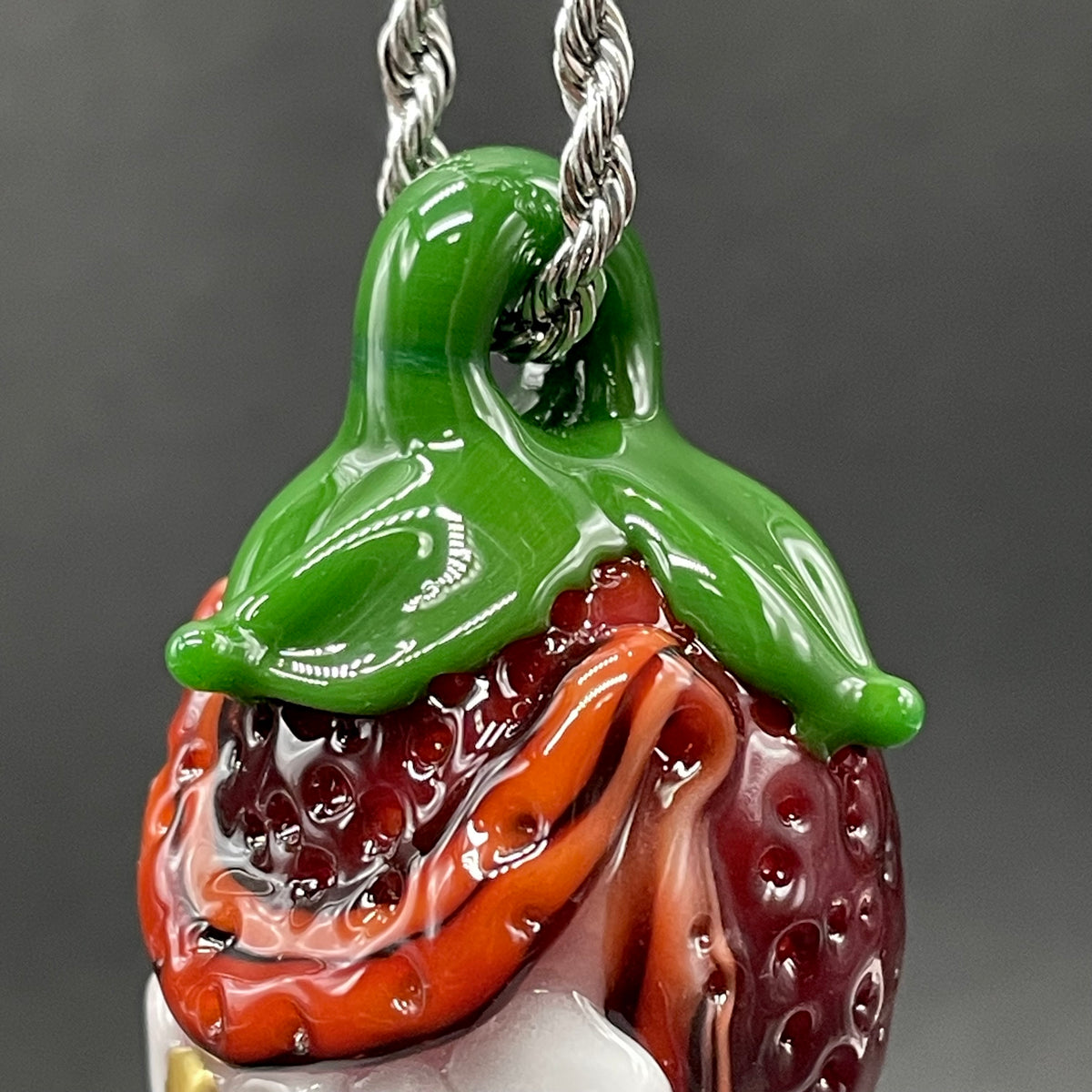 Toothy strawberry pendant detail view - premium glass art