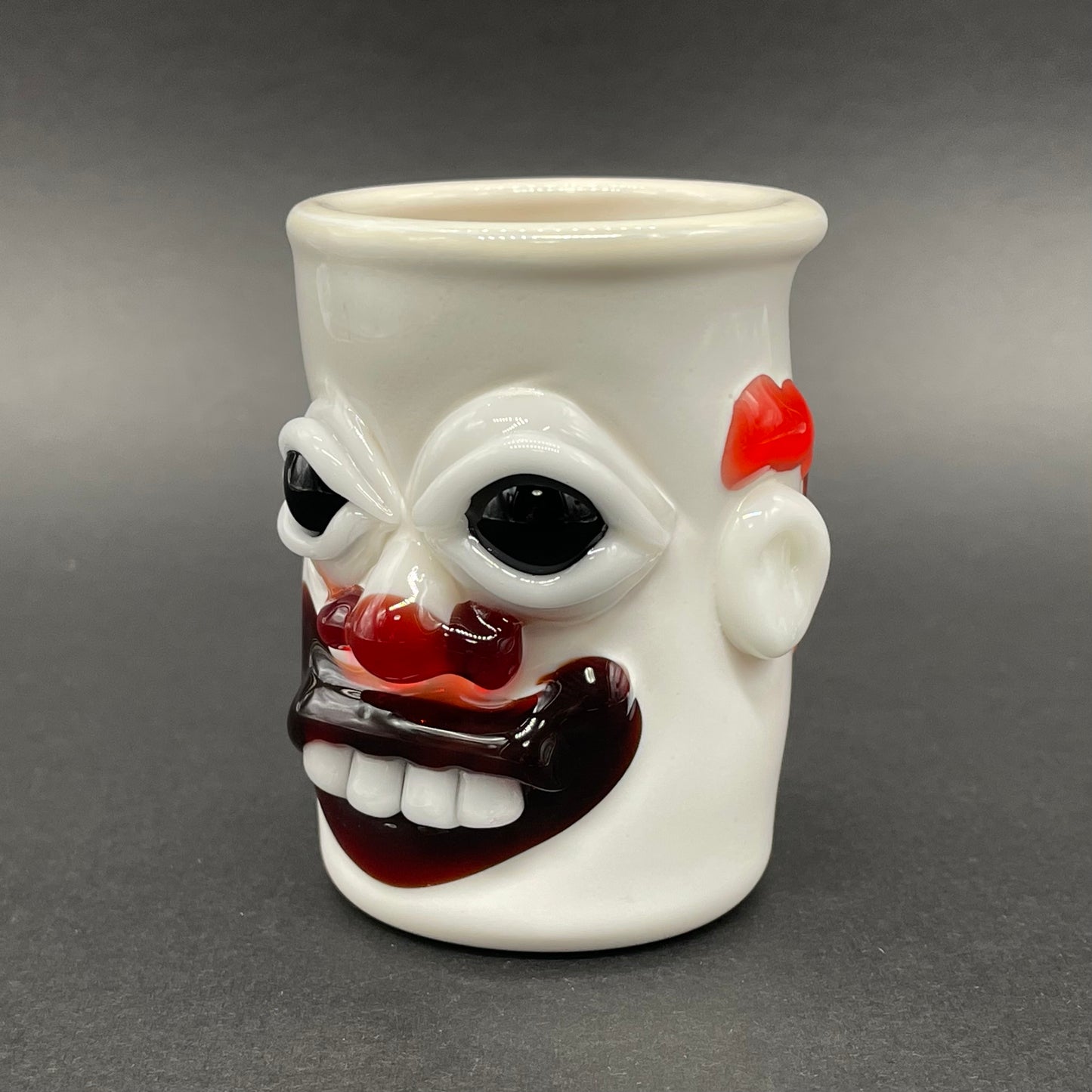 Close-up of Nightmare fuel Evil clown shot glass - handcrafted glass