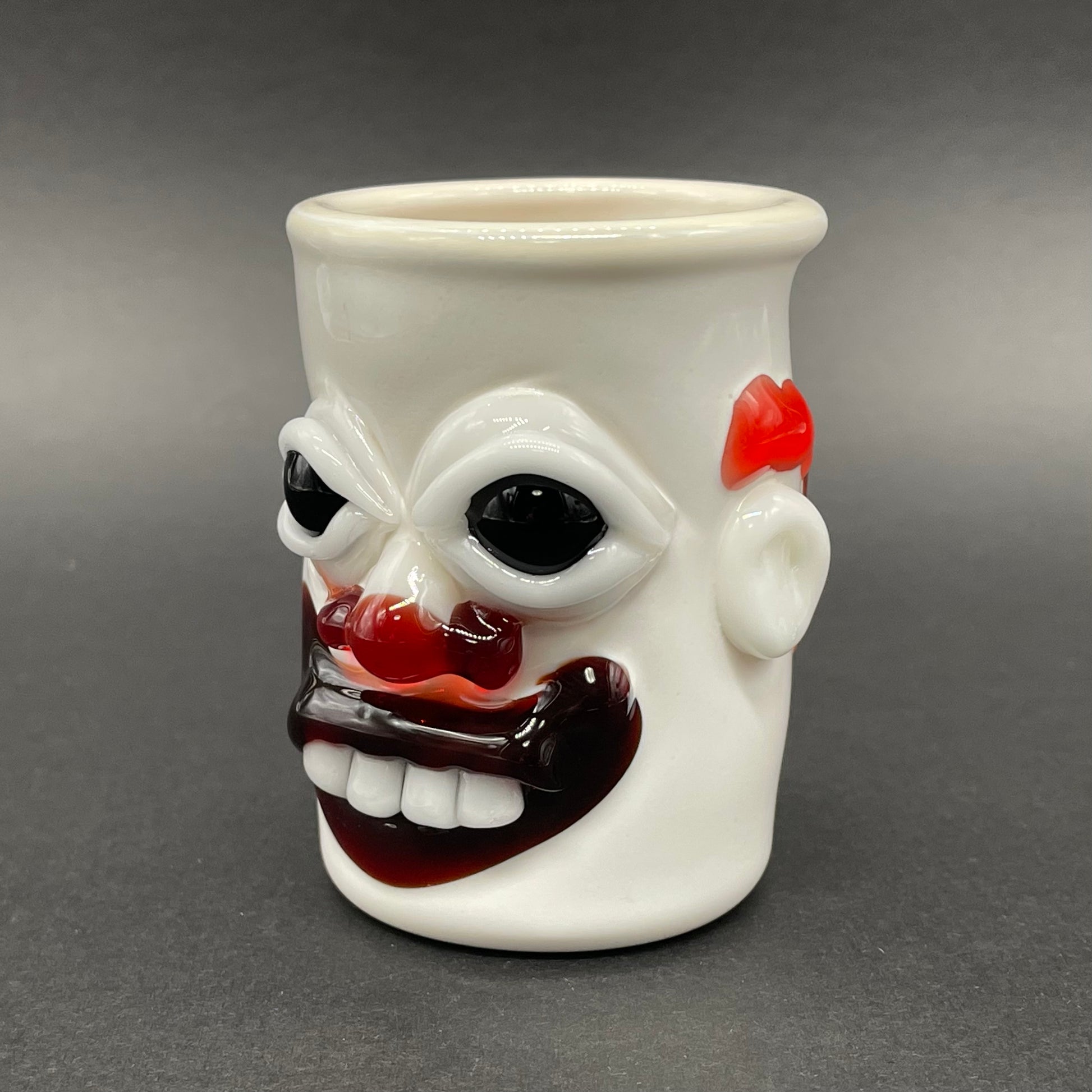 Close-up of Nightmare fuel Evil clown shot glass - handcrafted glass