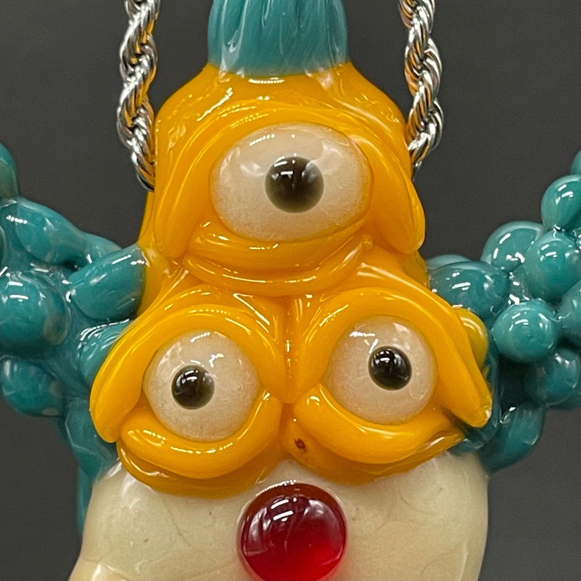 Krusty the Clown handblown glass pendant - Simpsons Krusty clown face with third eye, opal tab accent, white teeth, silver rope chain - Leviathan Glass