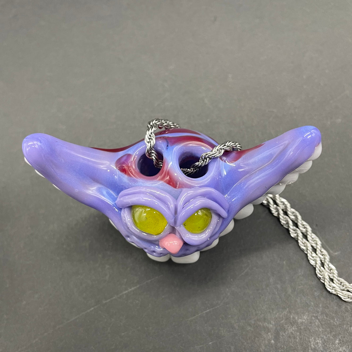 Grinning Cheshire cat glass pendant