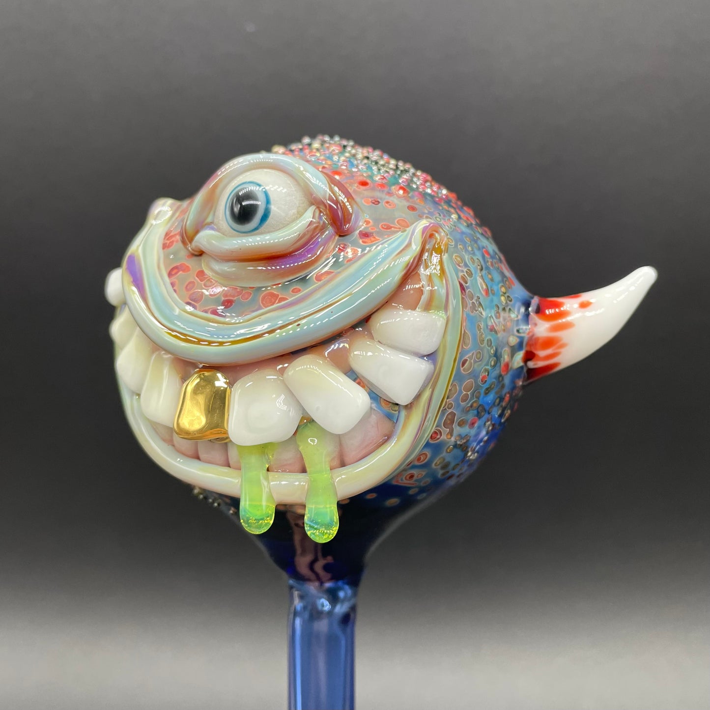 Hand Blown Glass Monster Watering Globe - round cyclops head, blue iris eye, white teeth, gold tooth, teal tongue drips, teal glass stake - Leviathan Glass