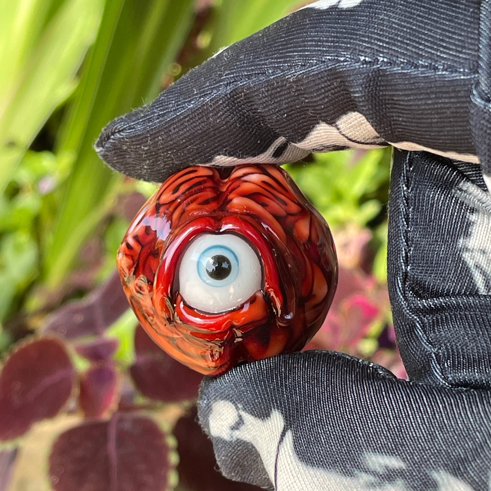 Close-up of Cyclops brain pendant - handcrafted glass