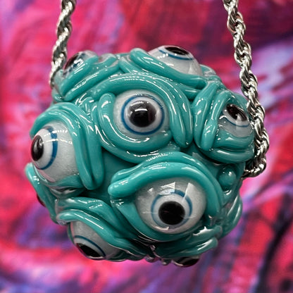 Close-up of Agua azule Argus pendant - handcrafted glass