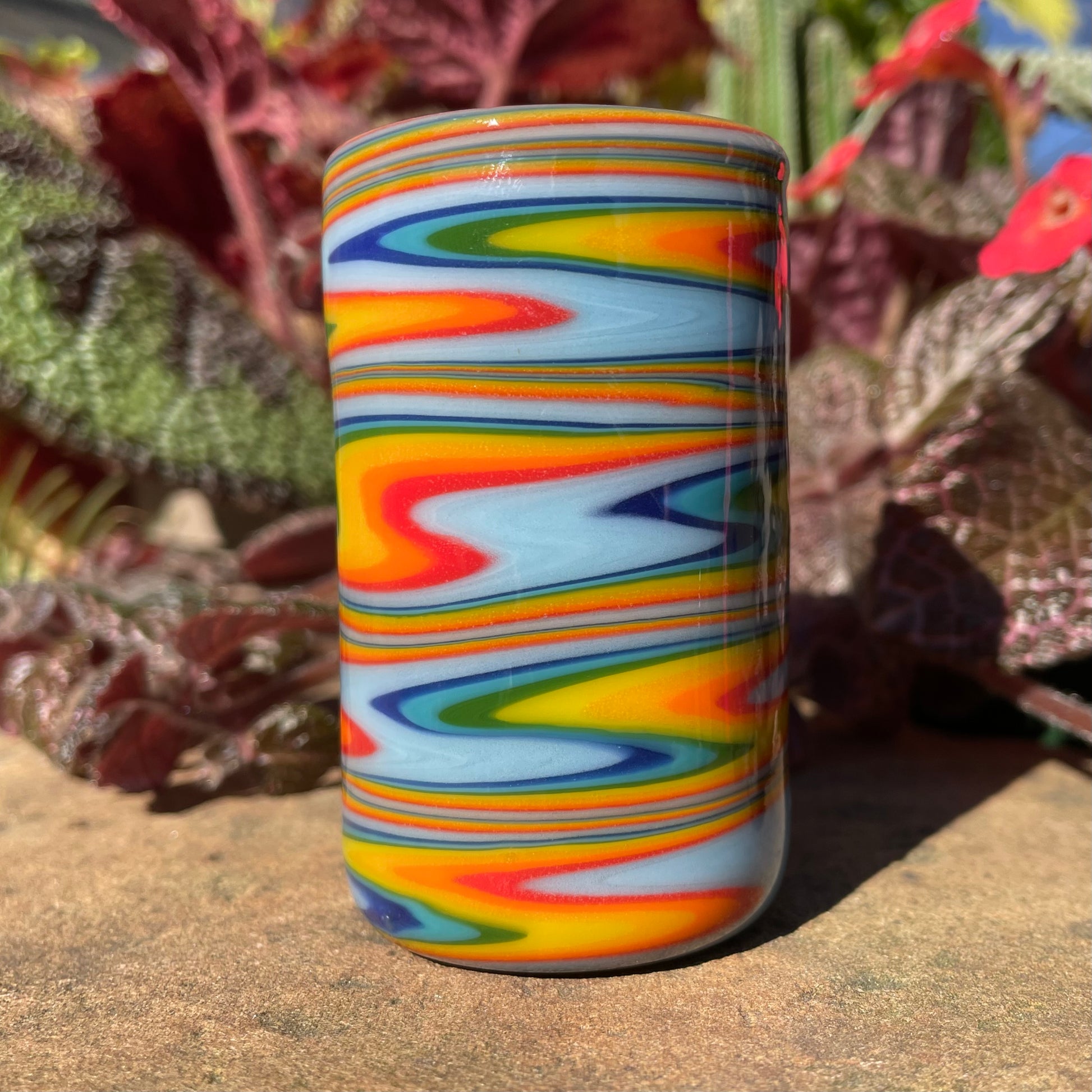 Close-up of rainbow wig wag shot glass - handcrafted glass