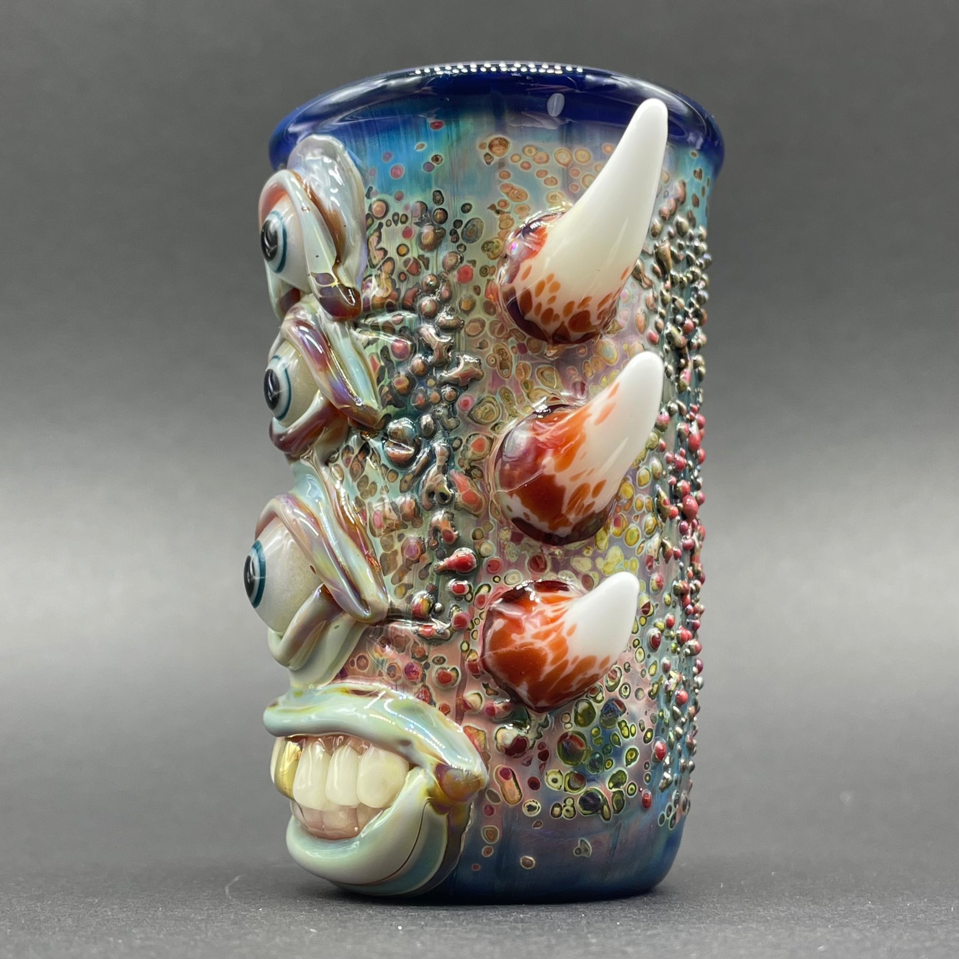Close-up of Vertical 3 eye shot glass - handcrafted glass