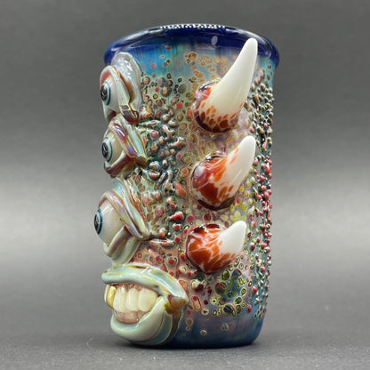 Close-up of Vertical 3 eye shot glass - handcrafted glass