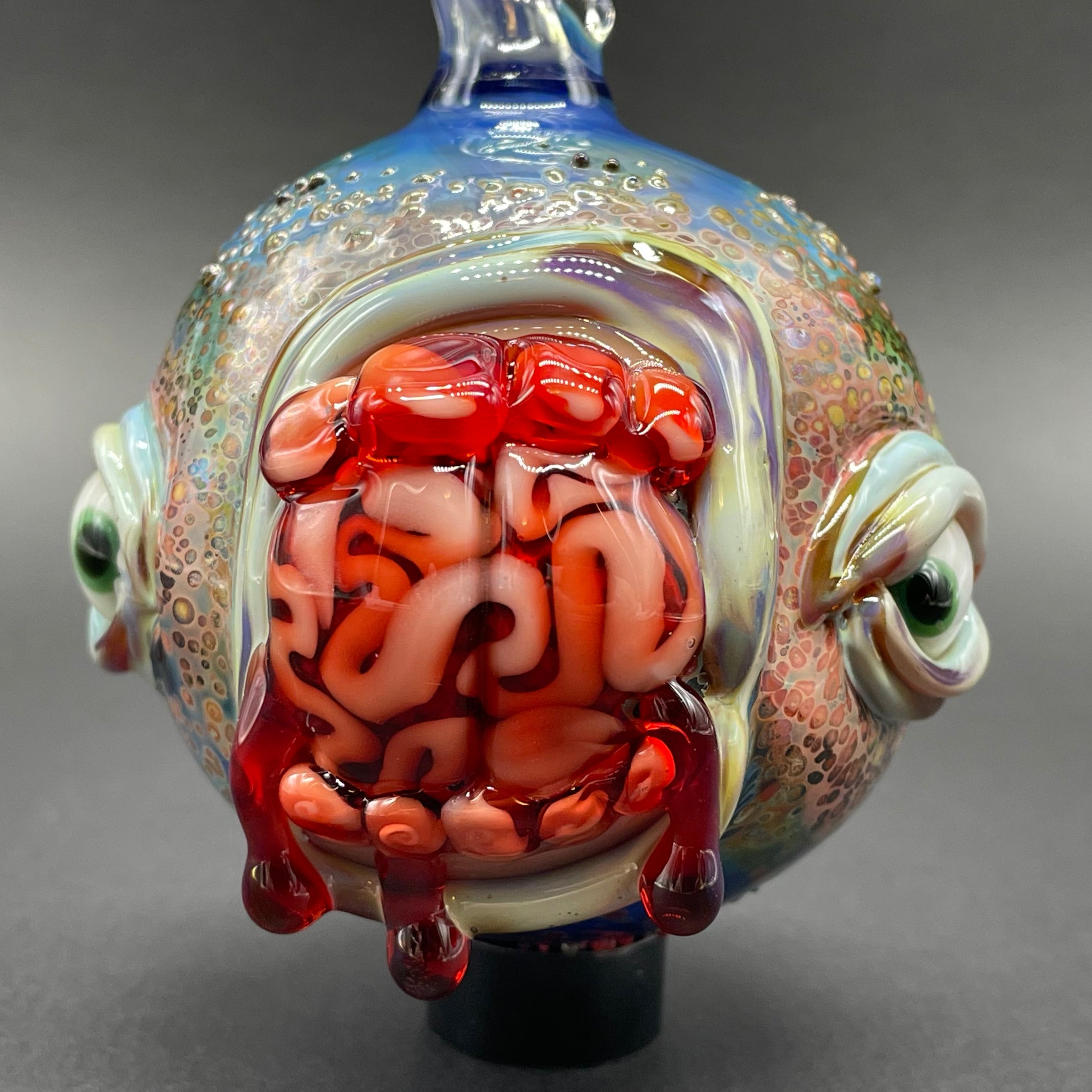 Close-up of Brain eating zombie ornament - handcrafted glass