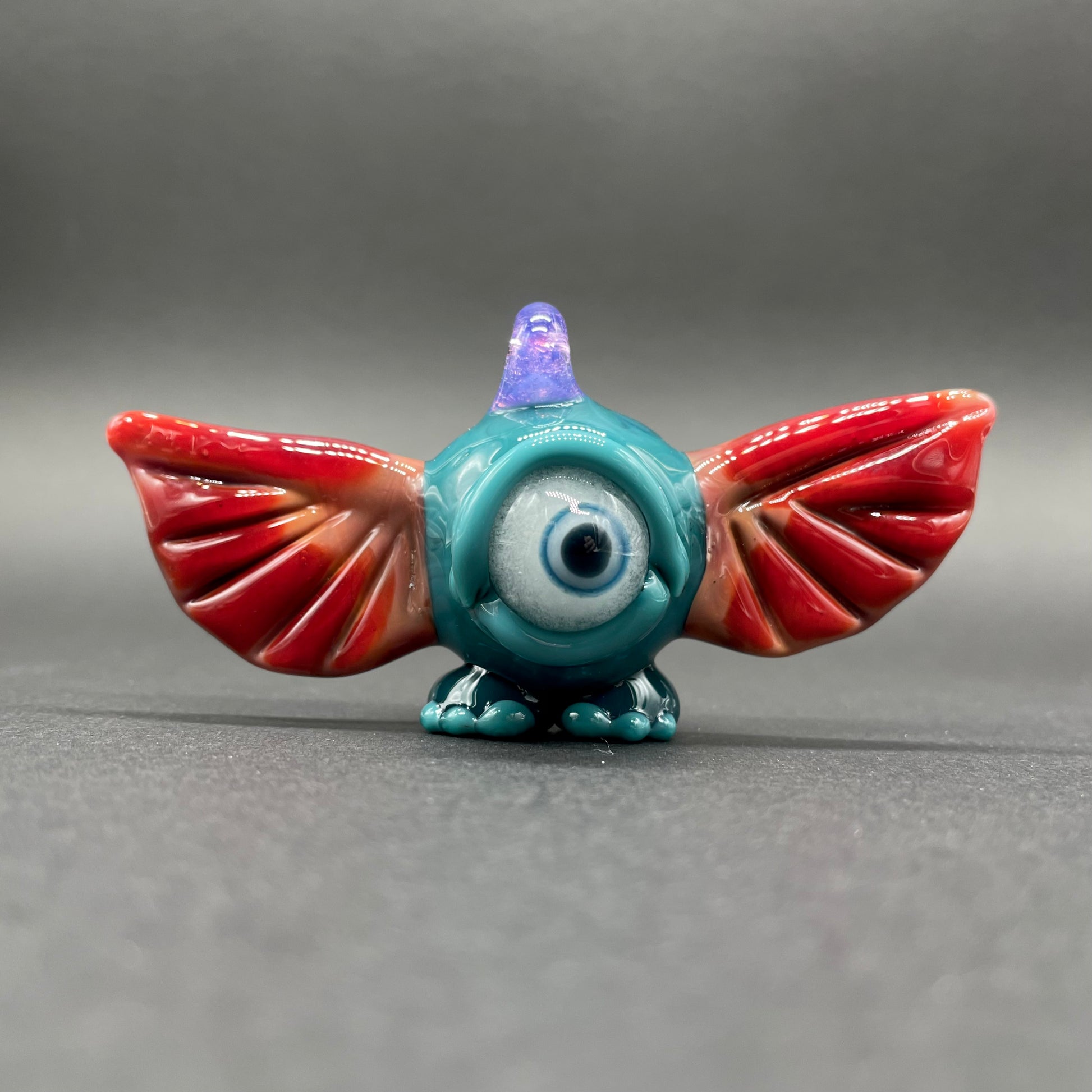 Hand-blown glass flying cyclops pendant by Leviathan Glass