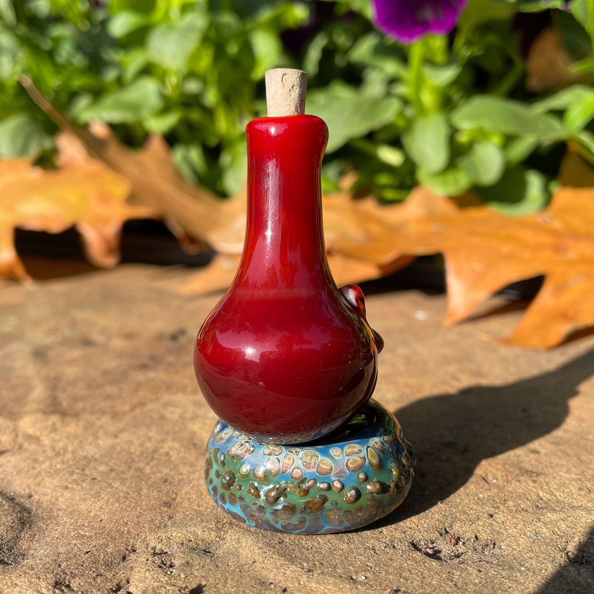 Artisan glass Red grinning glass cork bottle - detailed craftsmanship