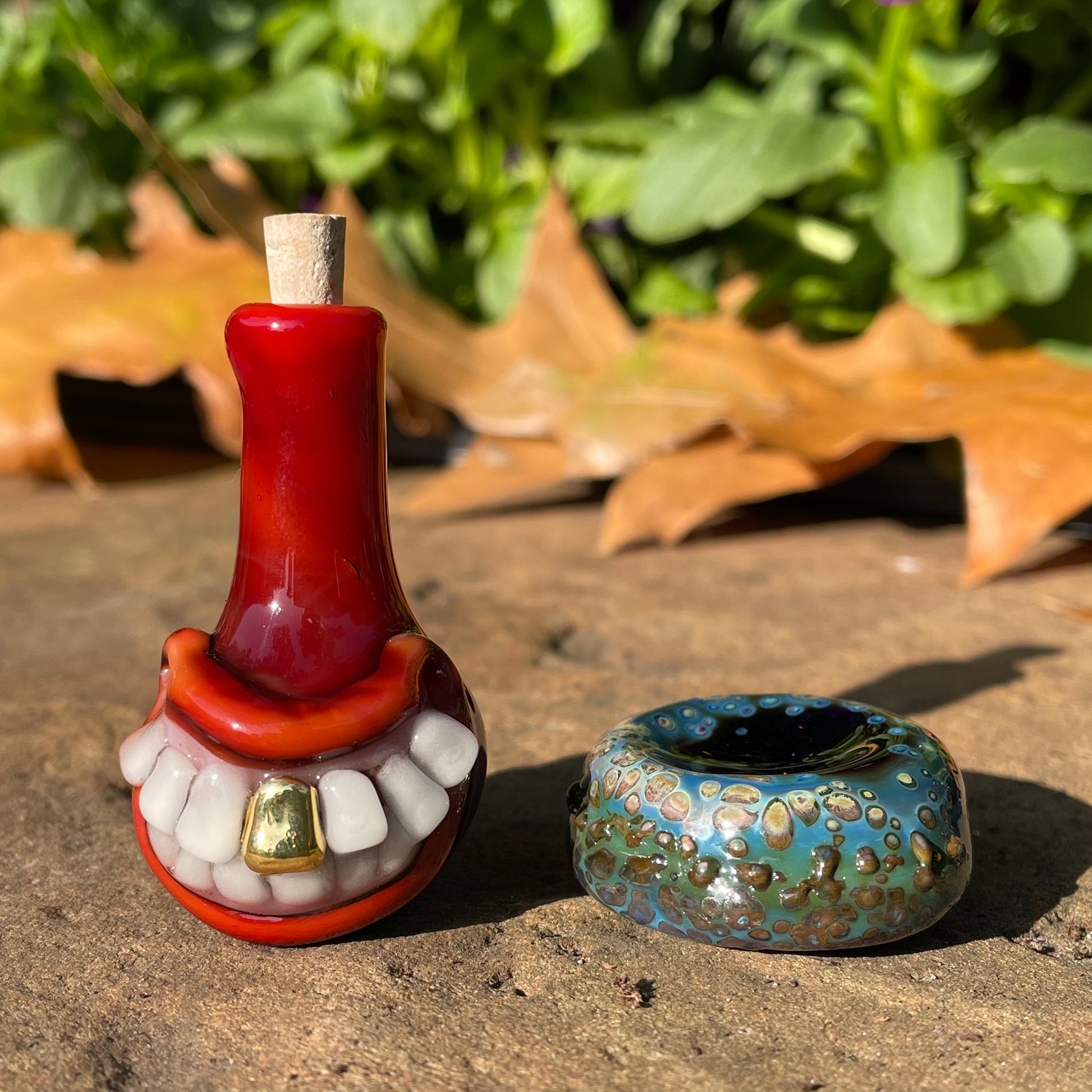 Close-up of Red grinning glass cork bottle - handcrafted glass