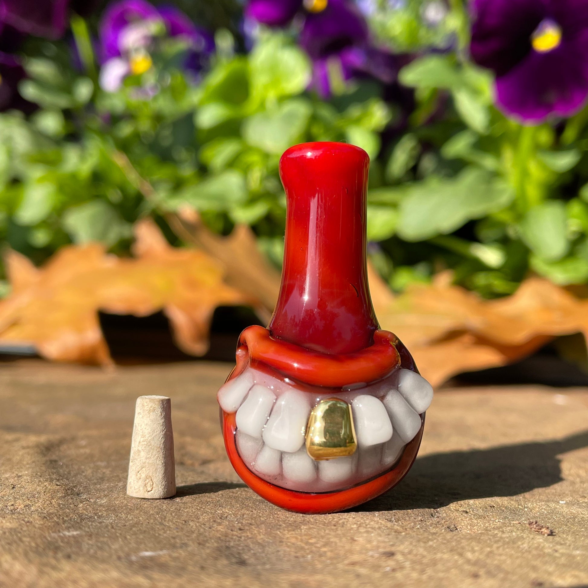 Red grinning glass cork bottle by Leviathan Glass - artisan detail