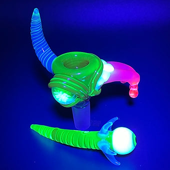 Close-up of 14mm red blacklight reactive slide set with tongue and horn - handcrafted glass