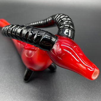 Close-up of large red taurus steamroller - handcrafted glass