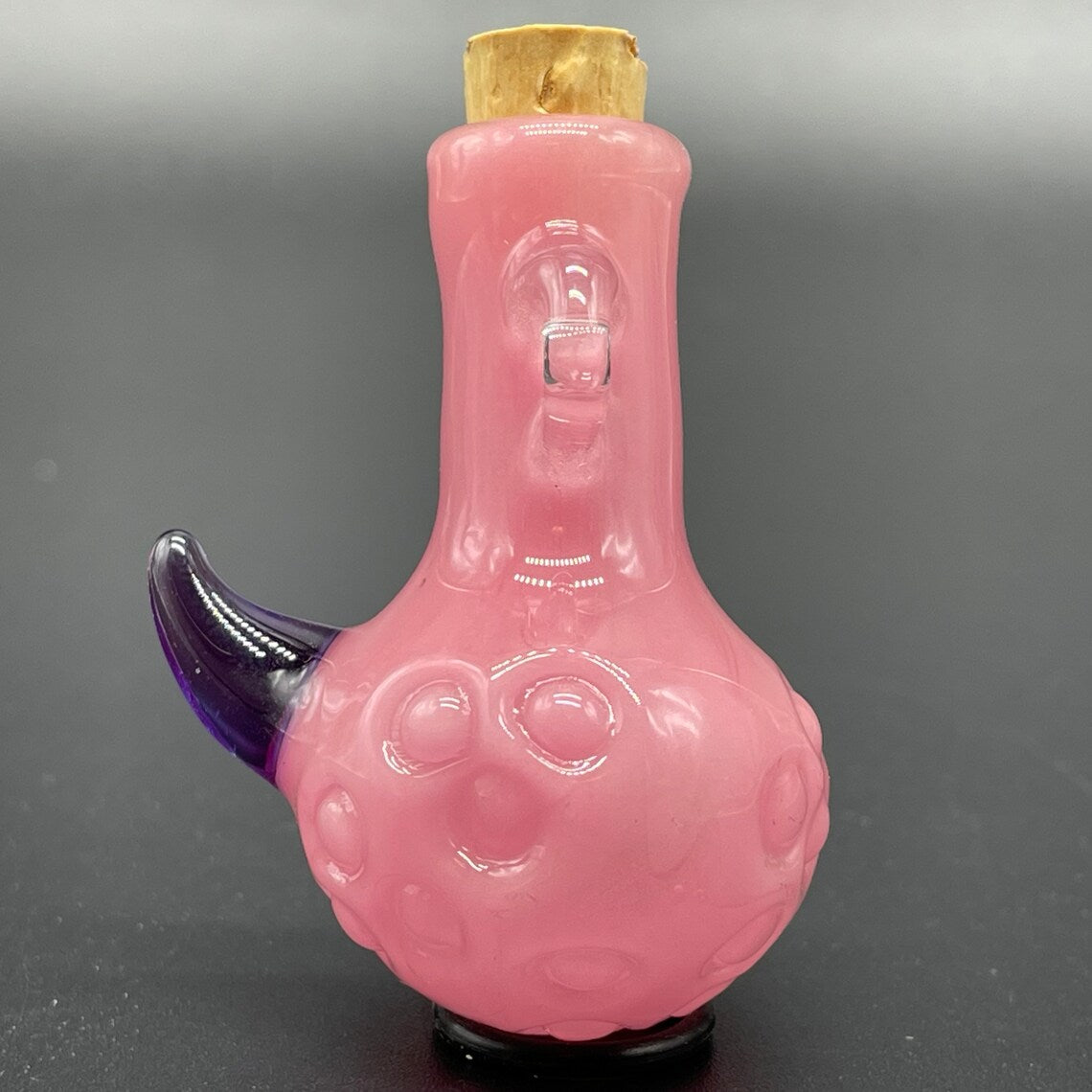 Close-up of Pink potion bottle / pendant - handcrafted glass