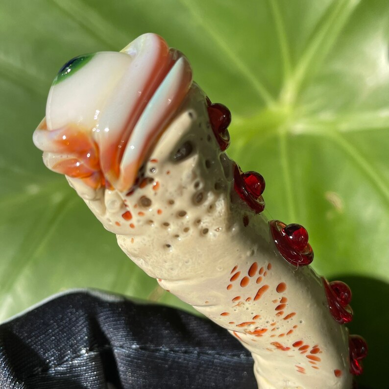 Premium Glass makeup brush with glow in the dark eye and red suckers. - collectible glass art