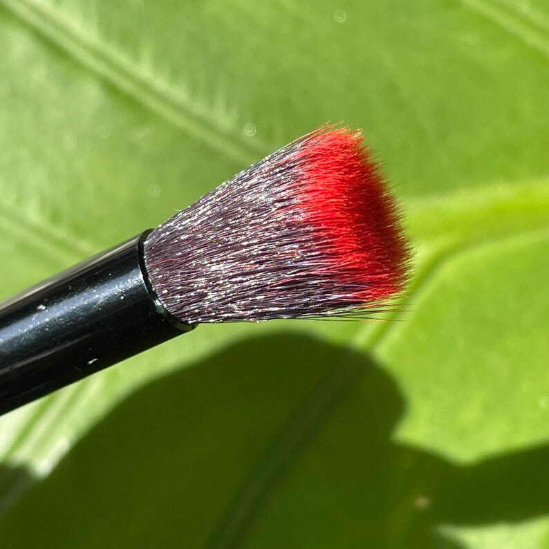 Glass makeup brush with glow in the dark eye and red suckers. detail view - premium glass art