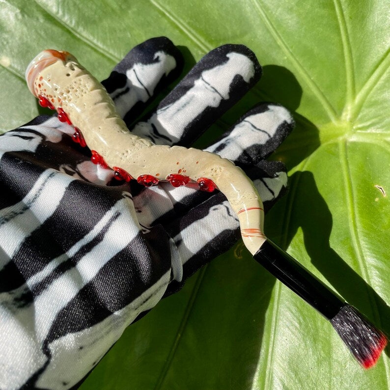 Hand-blown glass Glass makeup brush with glow in the dark eye and red suckers. by Leviathan Glass