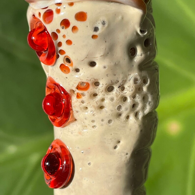 Glass makeup brush with glow in the dark eye and red suckers. glass art - premium handcrafted piece